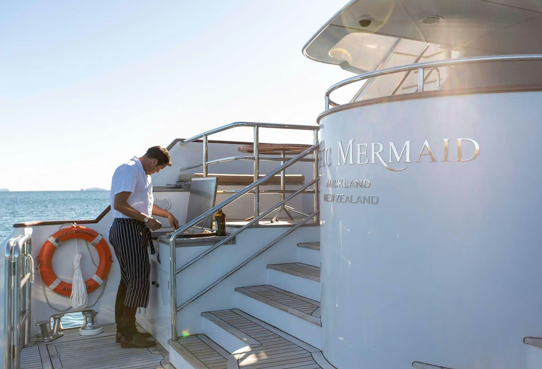 a man standing on a boat aboard PACIFIC MERMAID Yacht for Charter