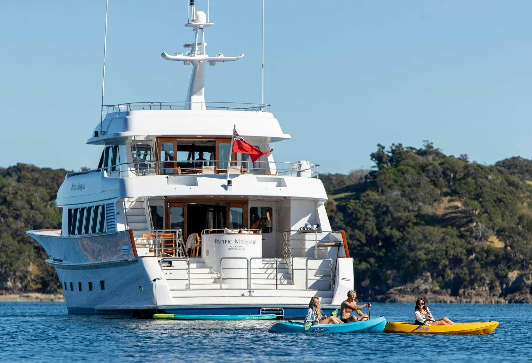 a boat with a flag on the front aboard PACIFIC MERMAID Yacht for Charter