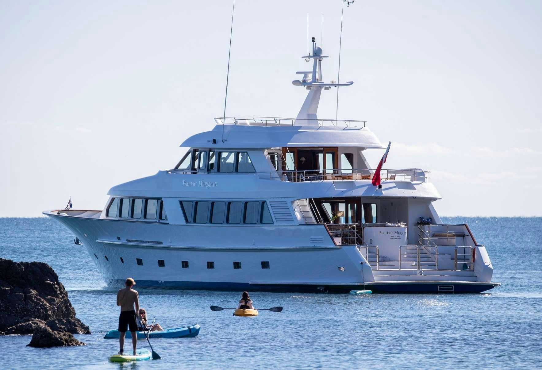 a large white boat in the water aboard PACIFIC MERMAID Yacht for Charter
