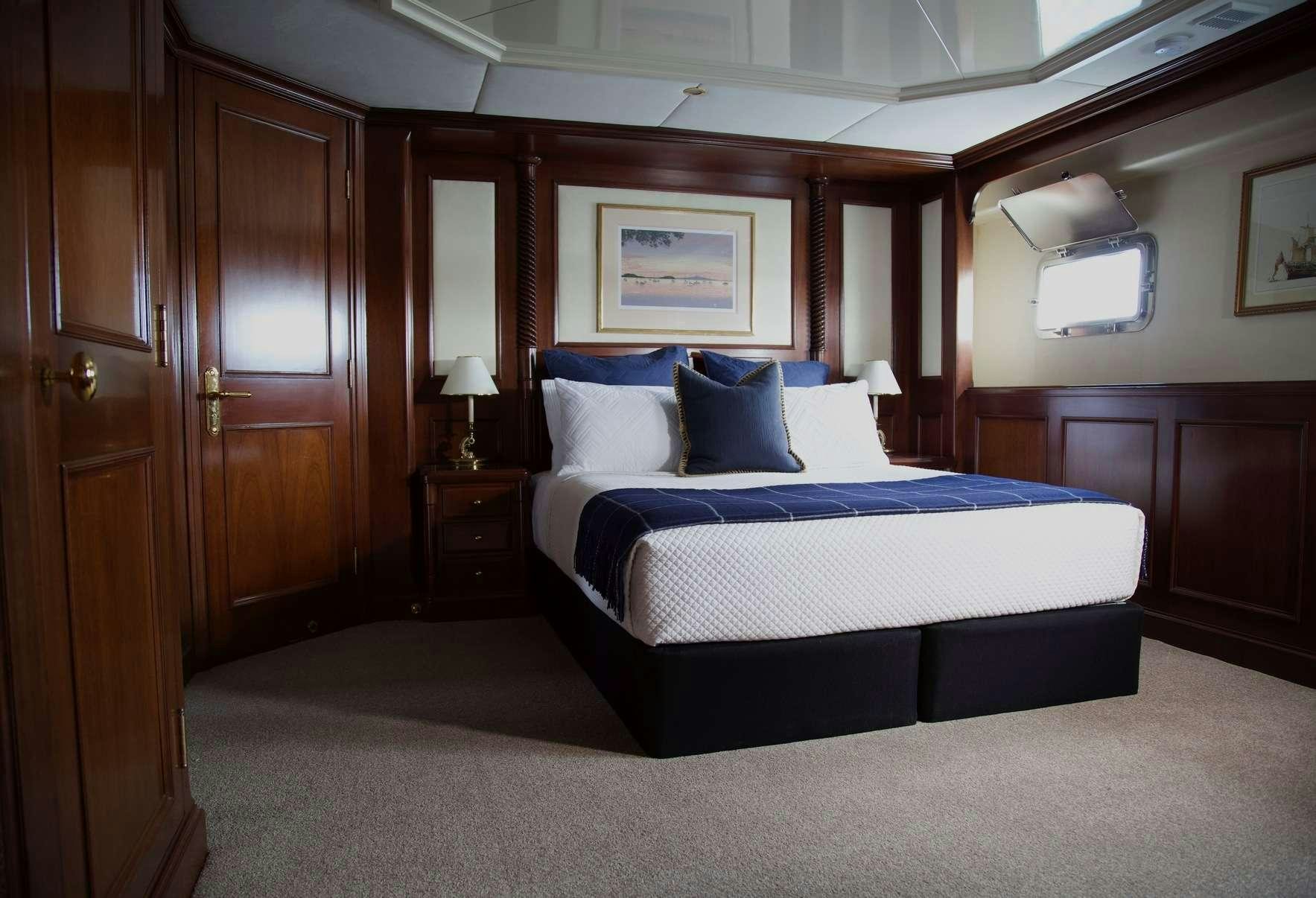 a bed in a room aboard PACIFIC MERMAID Yacht for Charter