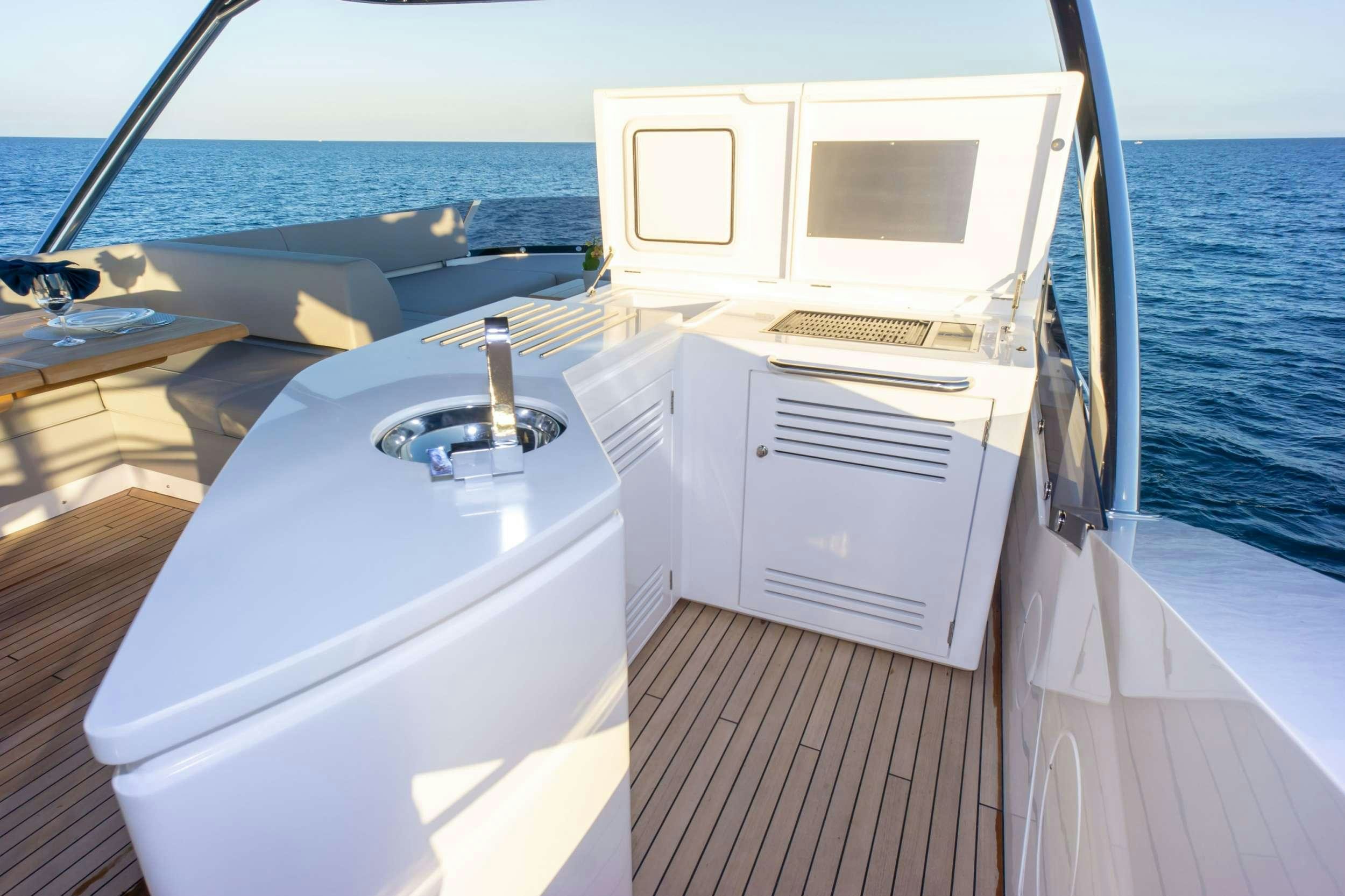 a boat with a sink and a computer on it aboard MILAMO Yacht for Charter