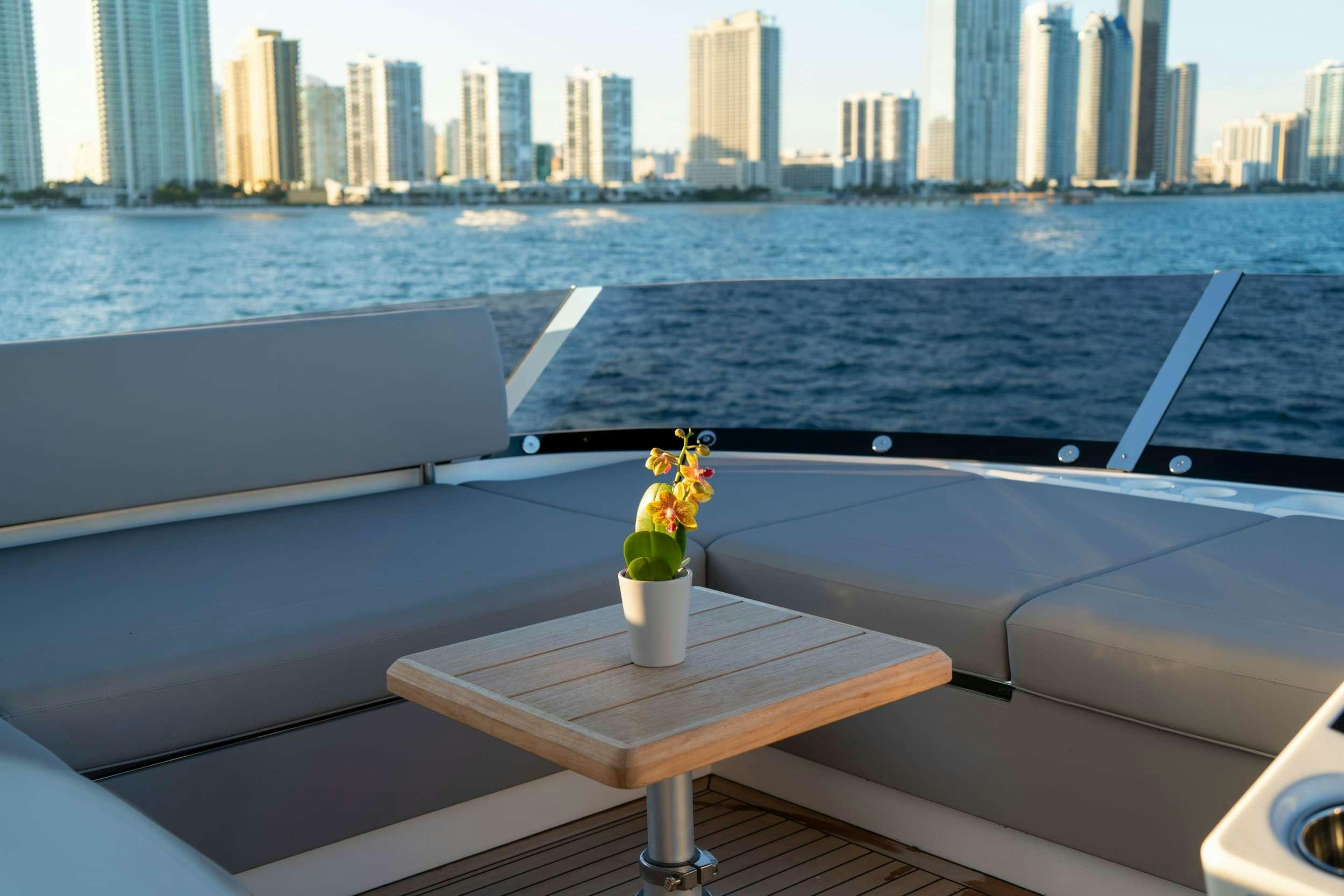 a vase of flowers on a table aboard MILAMO Yacht for Charter