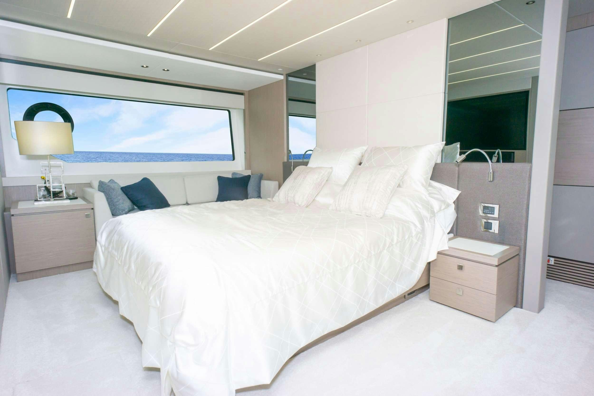a room with a bed and a television aboard MILAMO Yacht for Charter