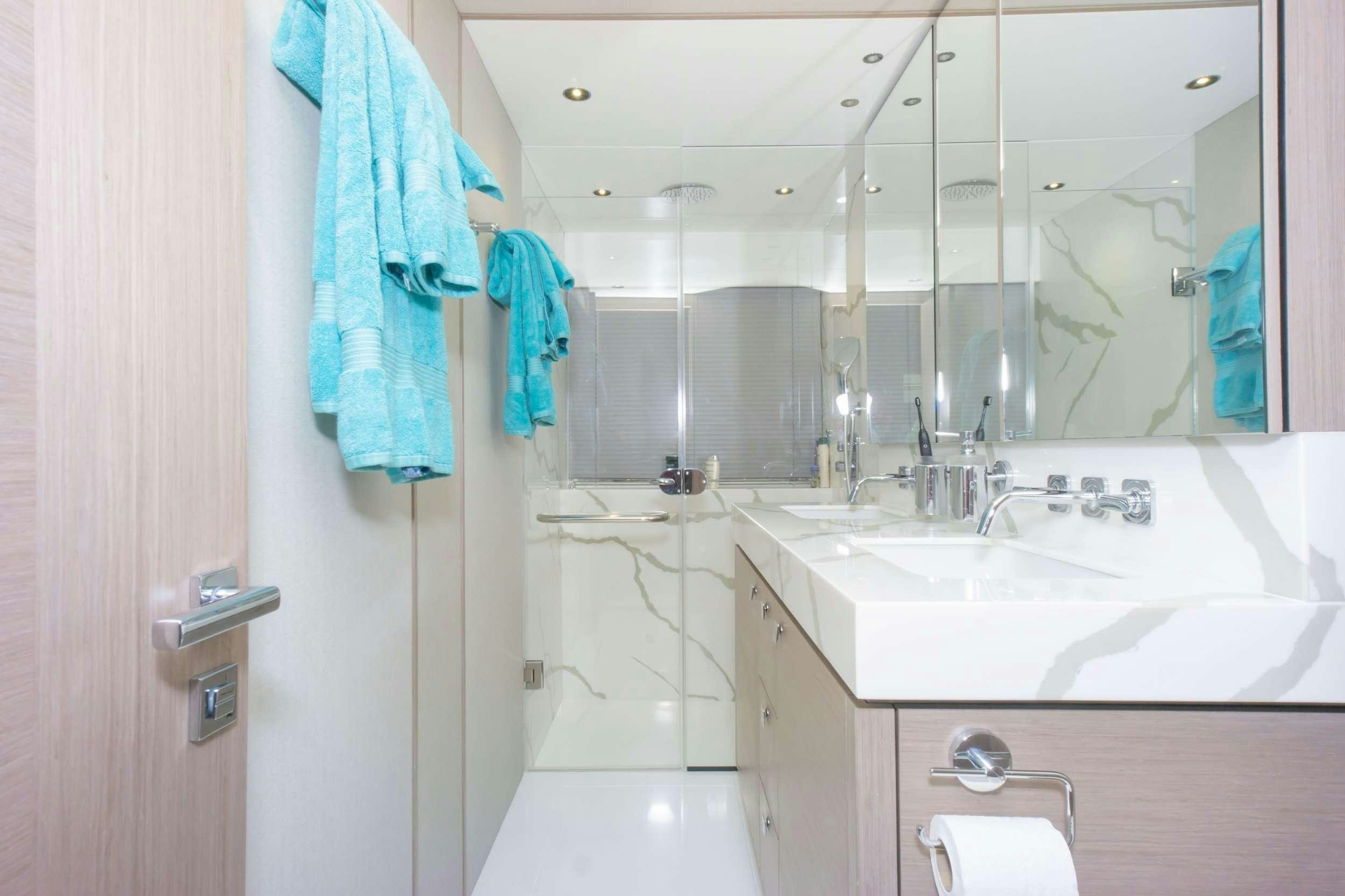 a bathroom with a sink and a mirror aboard MILAMO Yacht for Charter