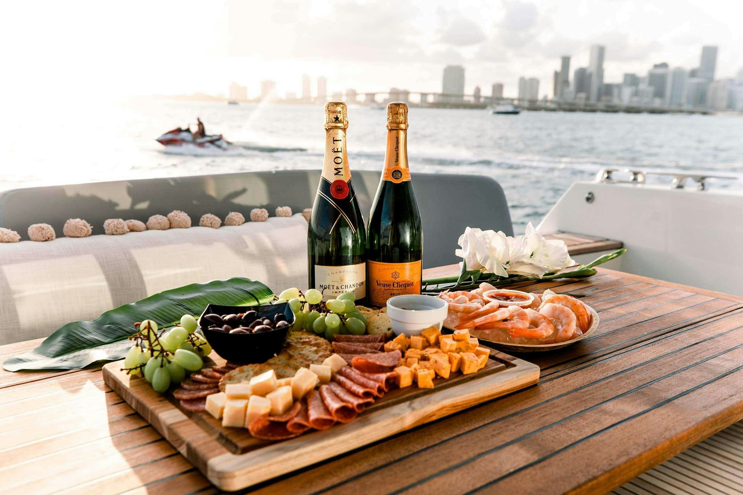 a table with food and wine bottles aboard Patinga, Fort Lauderdale Yacht for Charter