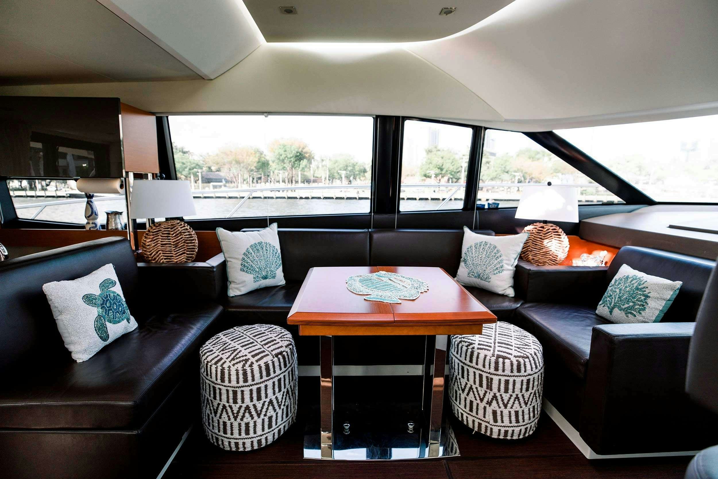 a living room with a couch and a table aboard Patinga, Fort Lauderdale Yacht for Charter