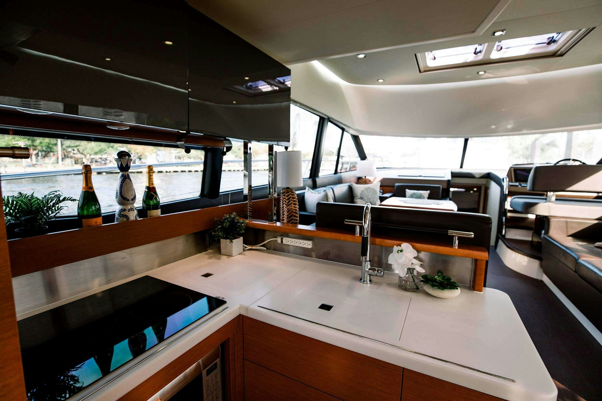 a room with a table and chairs aboard Patinga, Fort Lauderdale Yacht for Charter