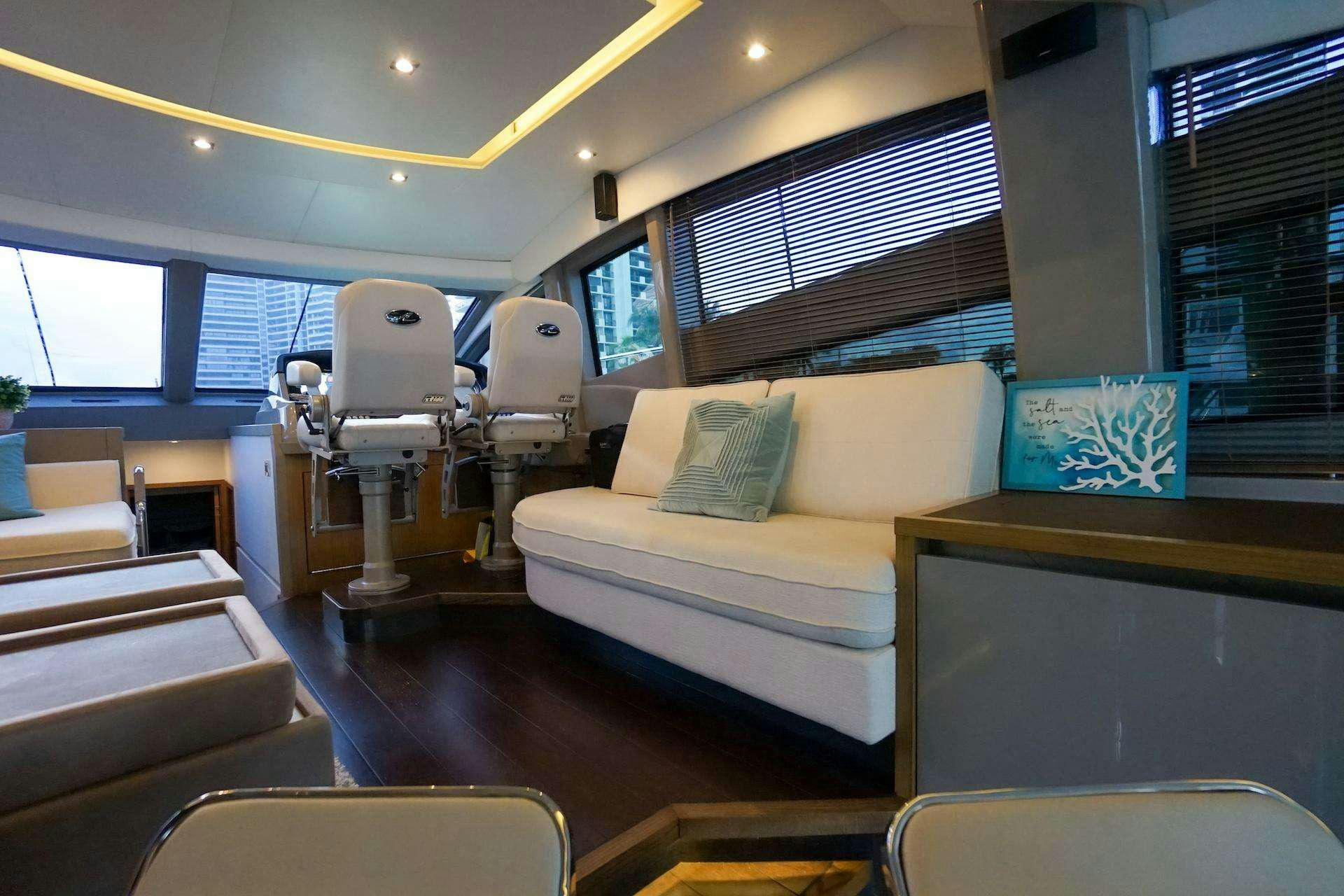 a room with a couch and a table and chairs aboard ISLANDER Yacht for Charter
