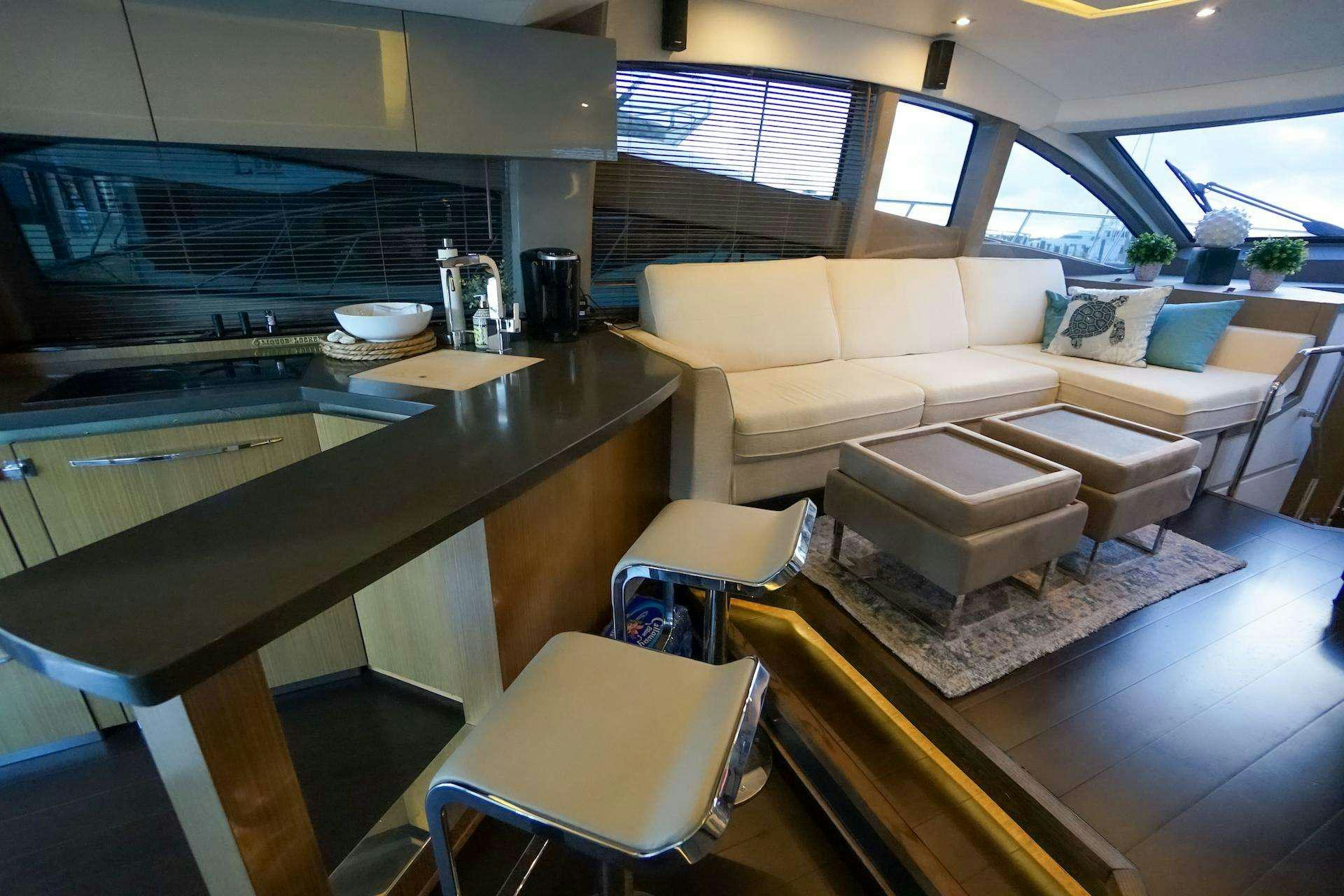 a living room with a table and couches aboard ISLANDER Yacht for Charter