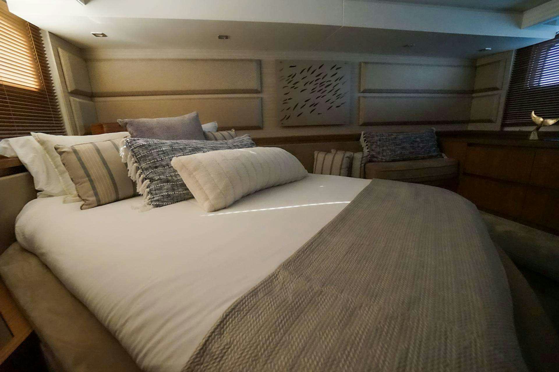a bed with white sheets aboard ISLANDER Yacht for Charter