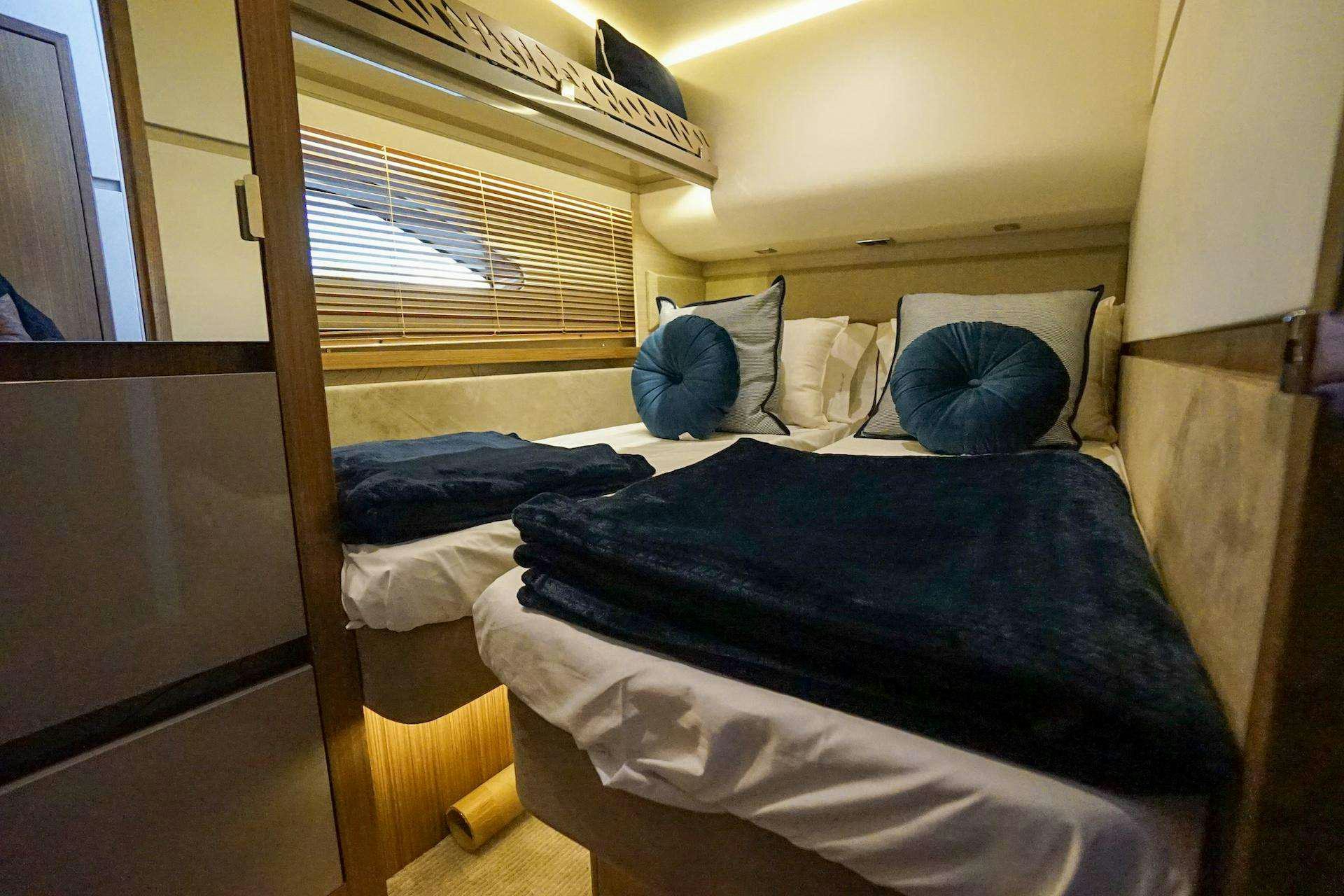 a bed with a blue sheet aboard ISLANDER Yacht for Charter