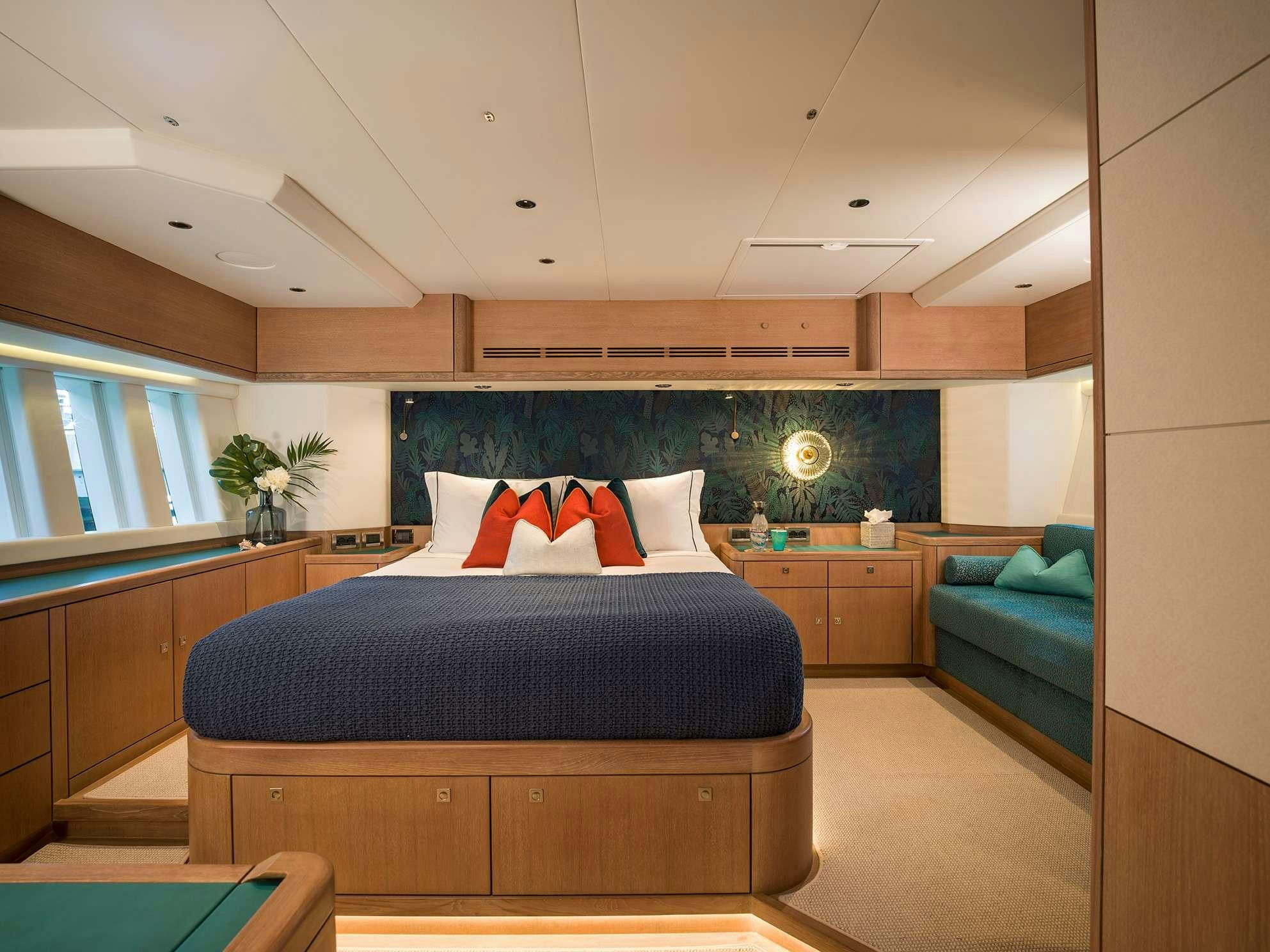 a bedroom with a bed and a couch aboard KARIBU Yacht for Charter