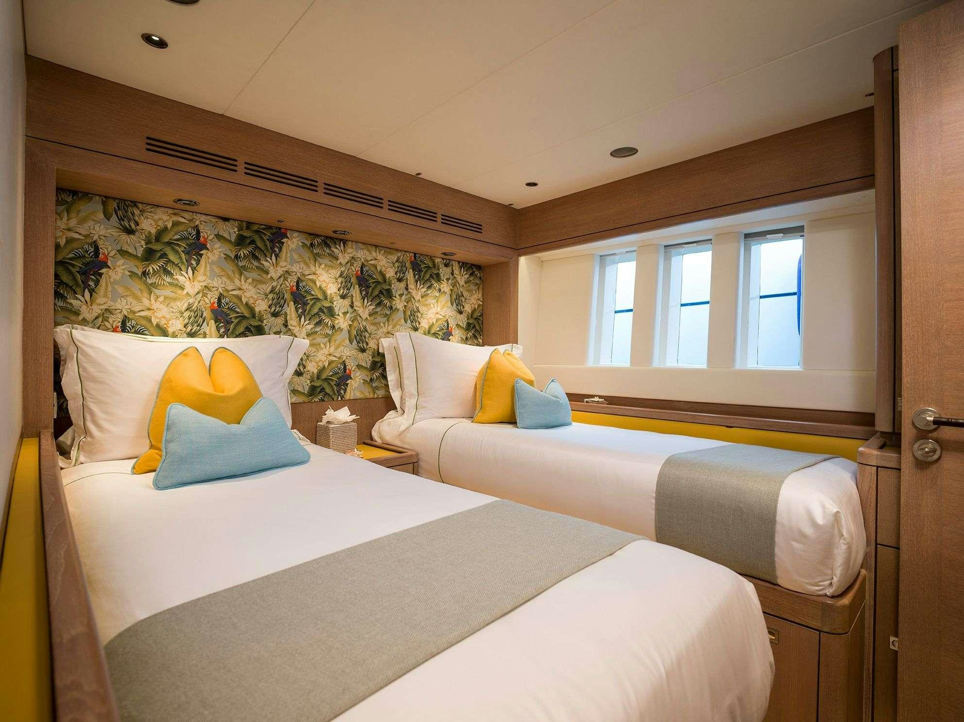 a couple of beds in a room aboard KARIBU Yacht for Charter