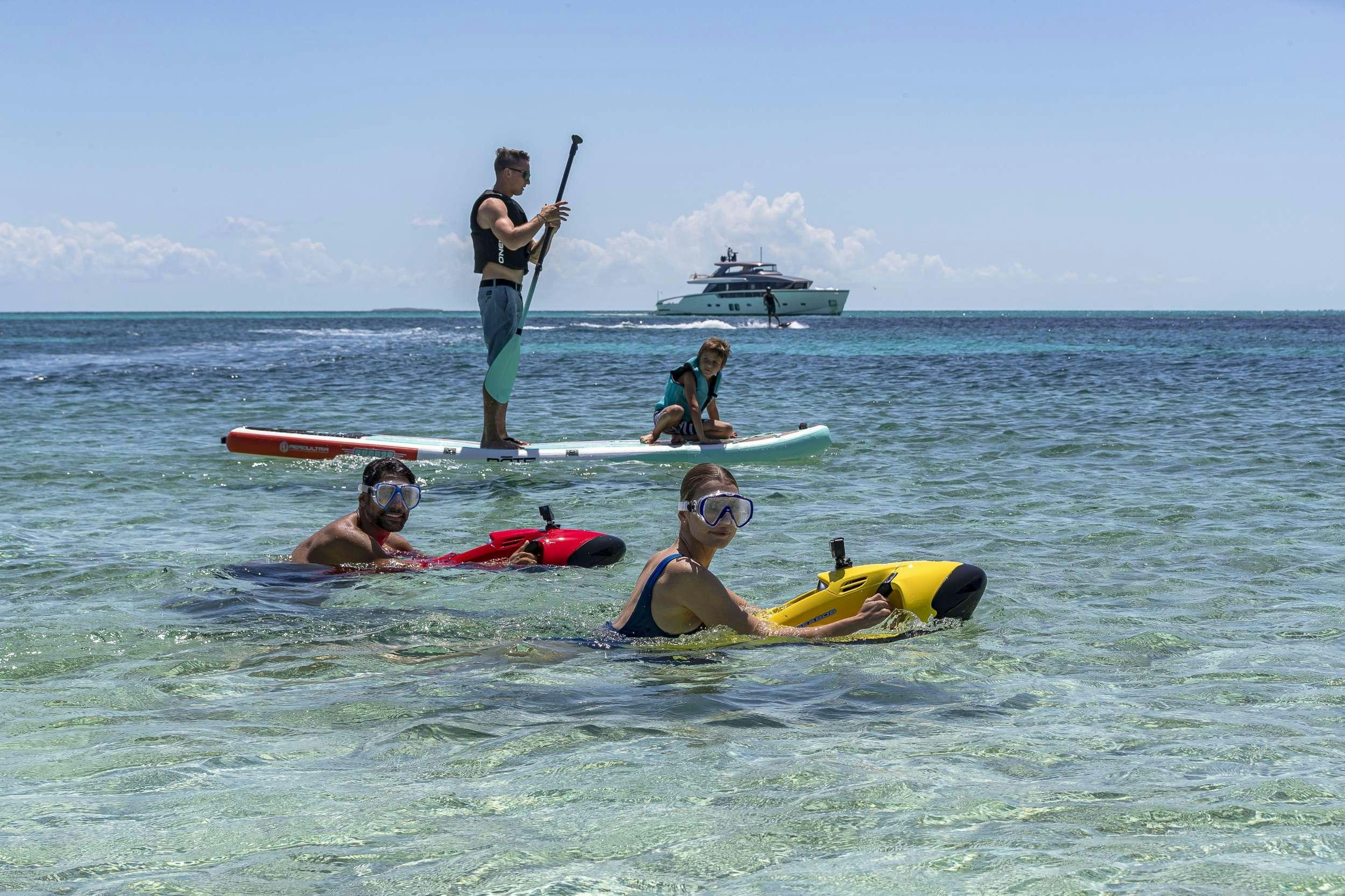 a group of people on surfboards in the ocean aboard NO MATTER WHAT Yacht for Charter