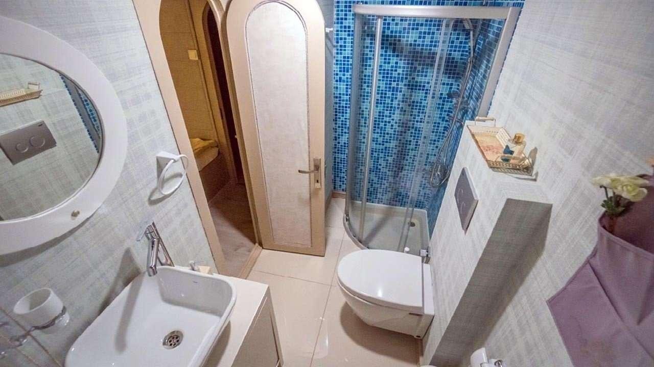 a bathroom with a shower and sinks aboard AMETIST A Yacht for Charter
