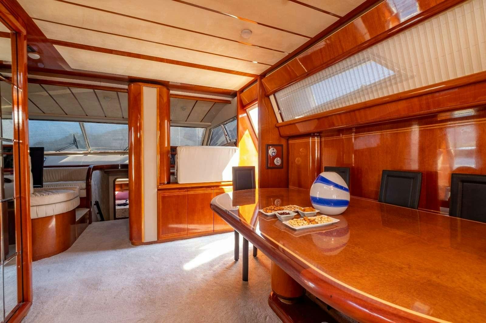 a room with a table and chairs aboard MIO AMORE Yacht for Charter