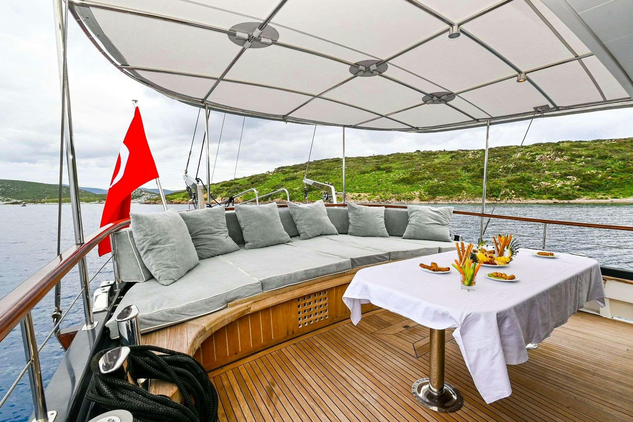 a couch and table on a boat aboard ESER 1 Yacht for Charter