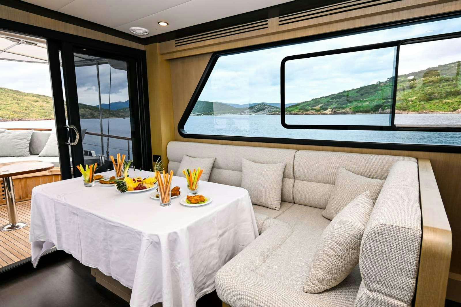 a table with a plate of food on it aboard ESER 1 Yacht for Charter