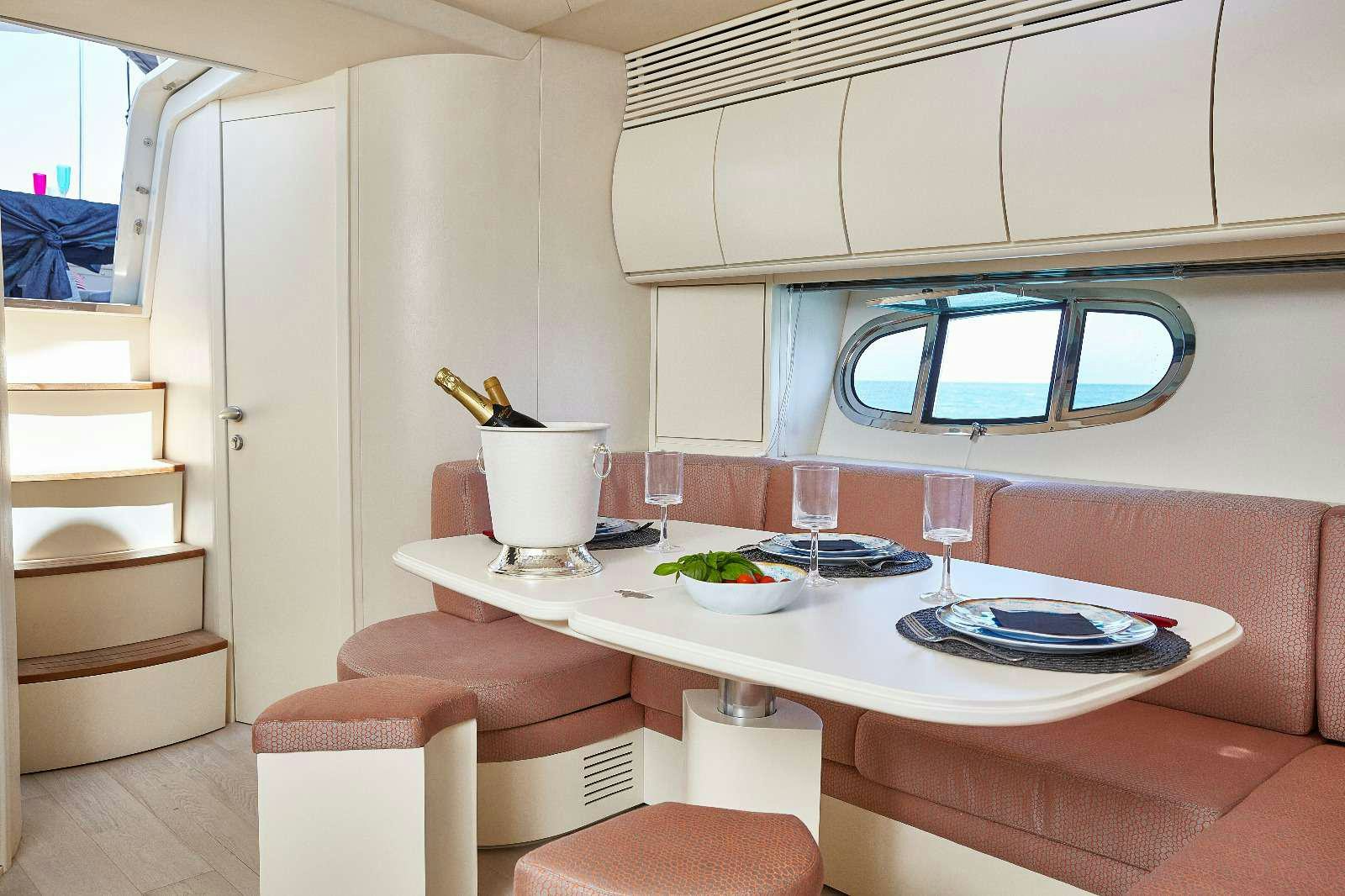 a dining table with plates and glasses aboard SOPHIA Yacht for Charter