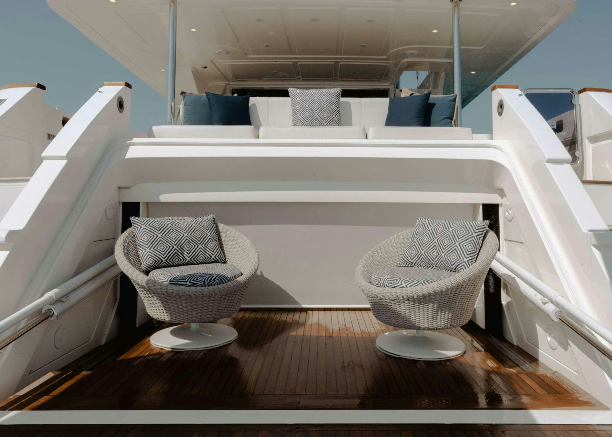 a room with a chair and a table and chairs aboard BONUS ROUND Yacht for Charter
