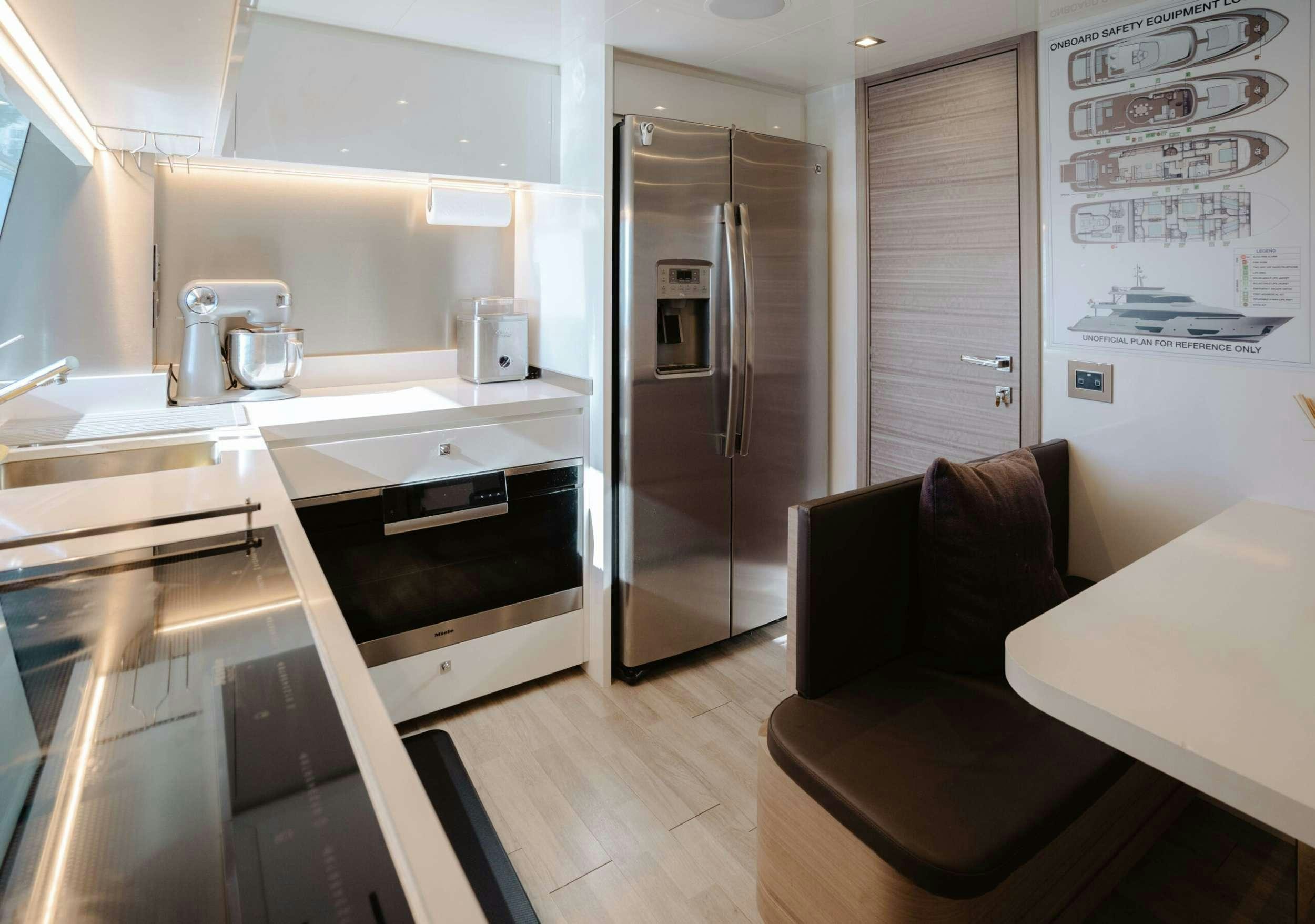 a kitchen with a couch and a refrigerator aboard BONUS ROUND Yacht for Charter