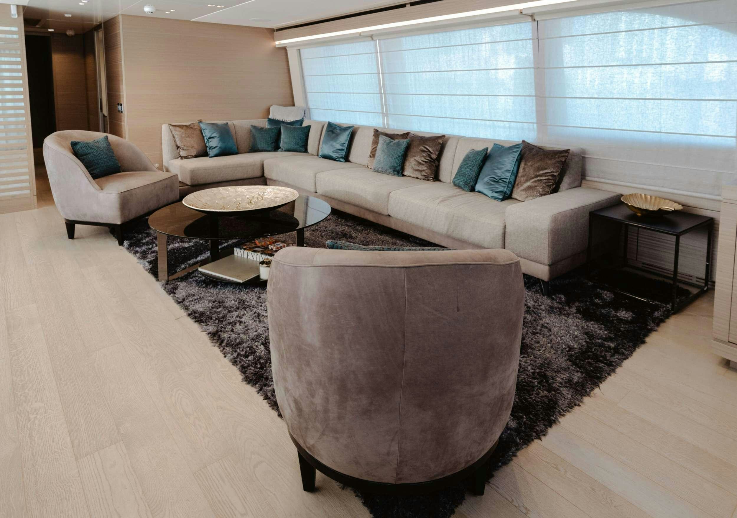 a living room with a couch and a coffee table aboard BONUS ROUND Yacht for Charter