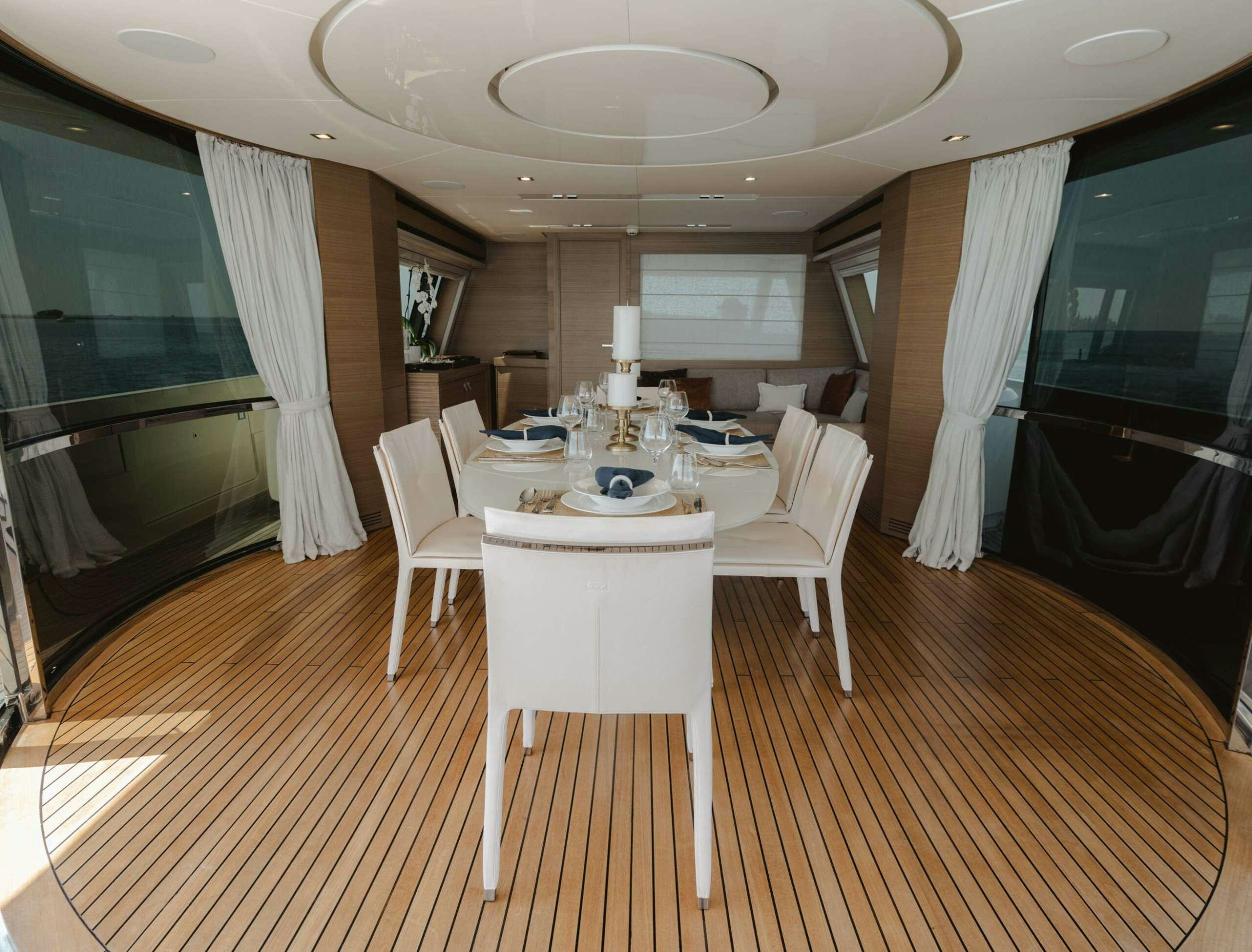 a room with a table and chairs aboard BONUS ROUND Yacht for Charter