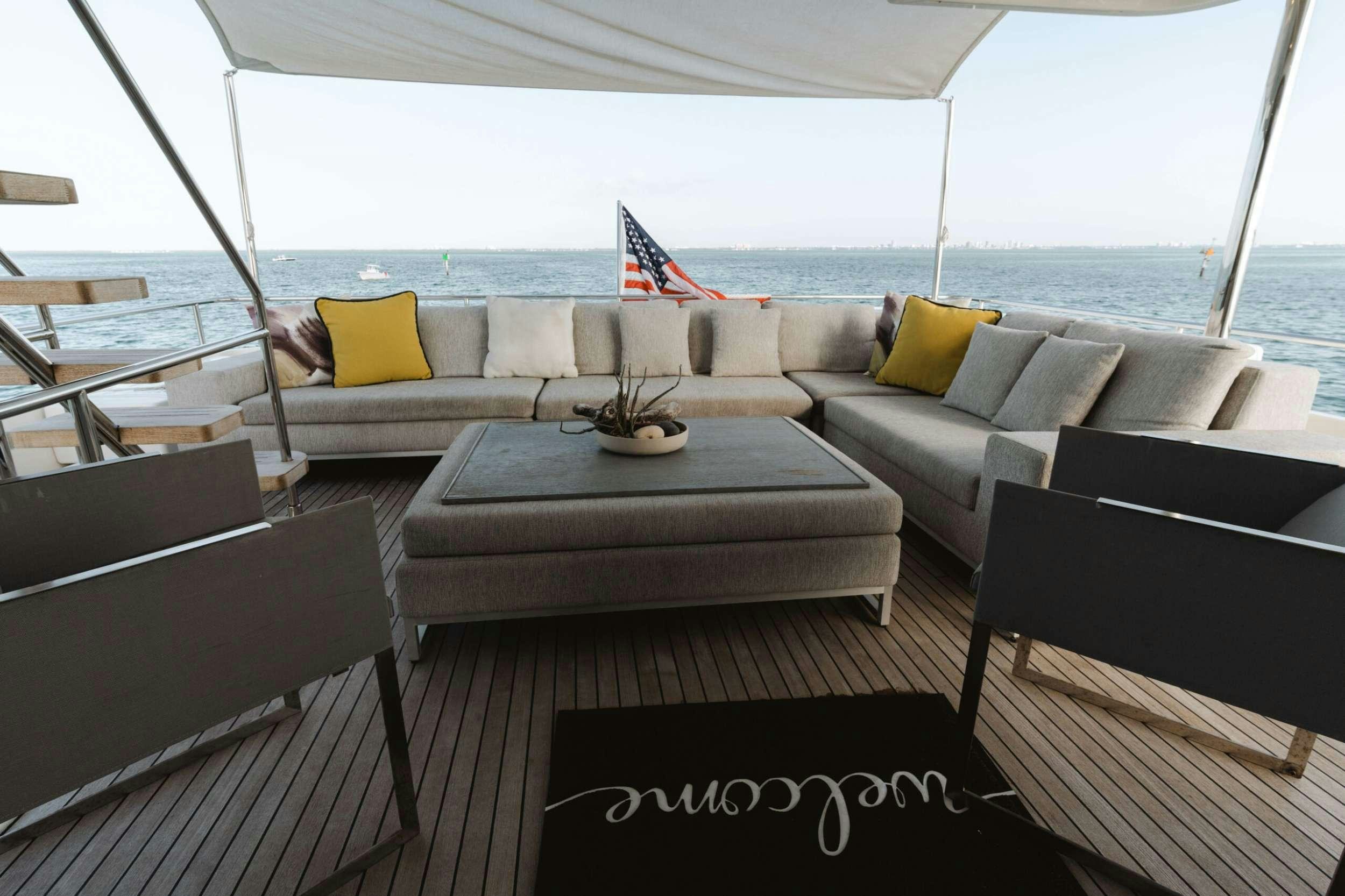 a room with couches and a table and chairs aboard BONUS ROUND Yacht for Charter