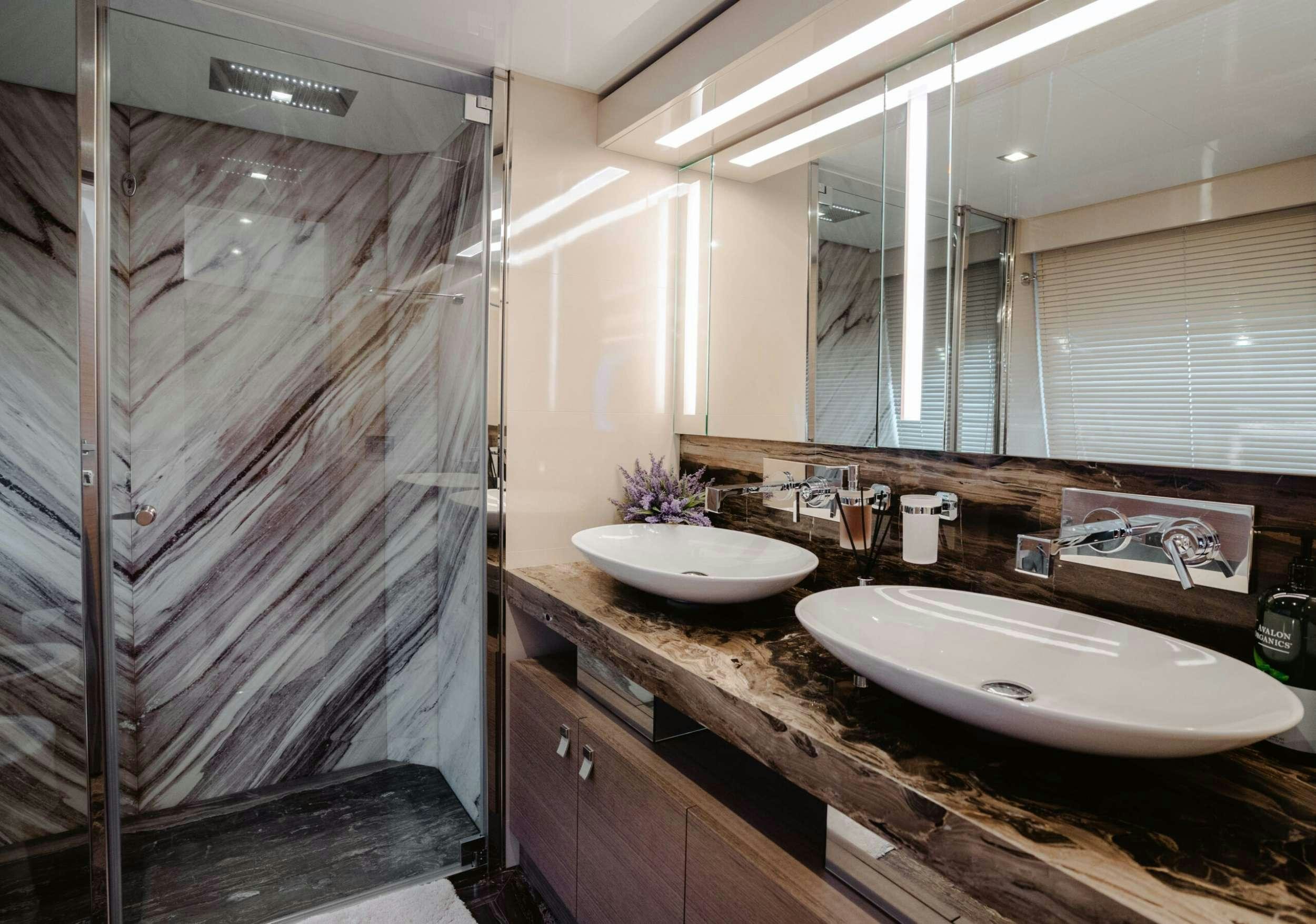 a bathroom with a sink and a shower aboard BONUS ROUND Yacht for Charter