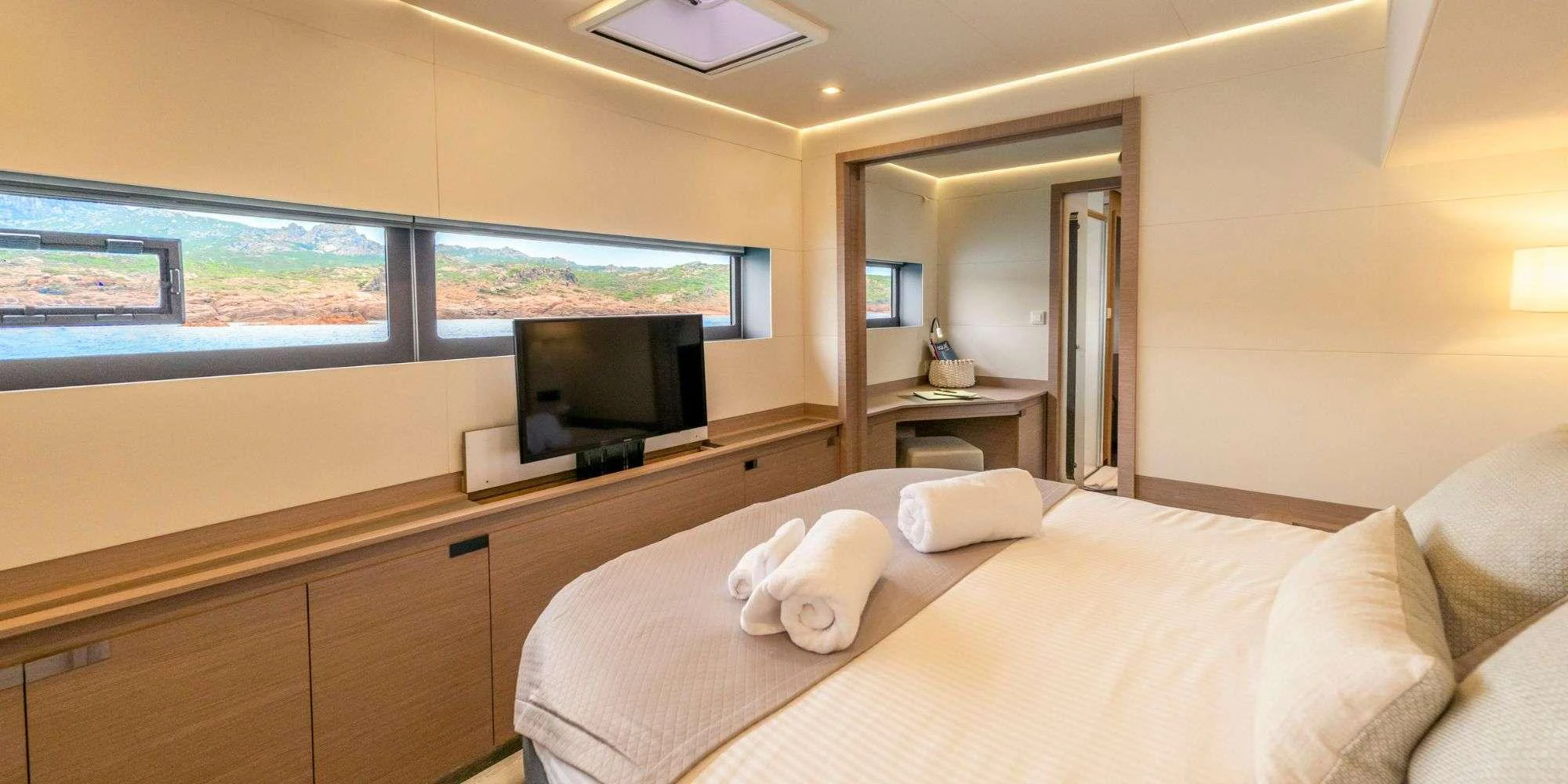 a hotel room with a bed and tv aboard SEMPER FIDELIS Yacht for Charter
