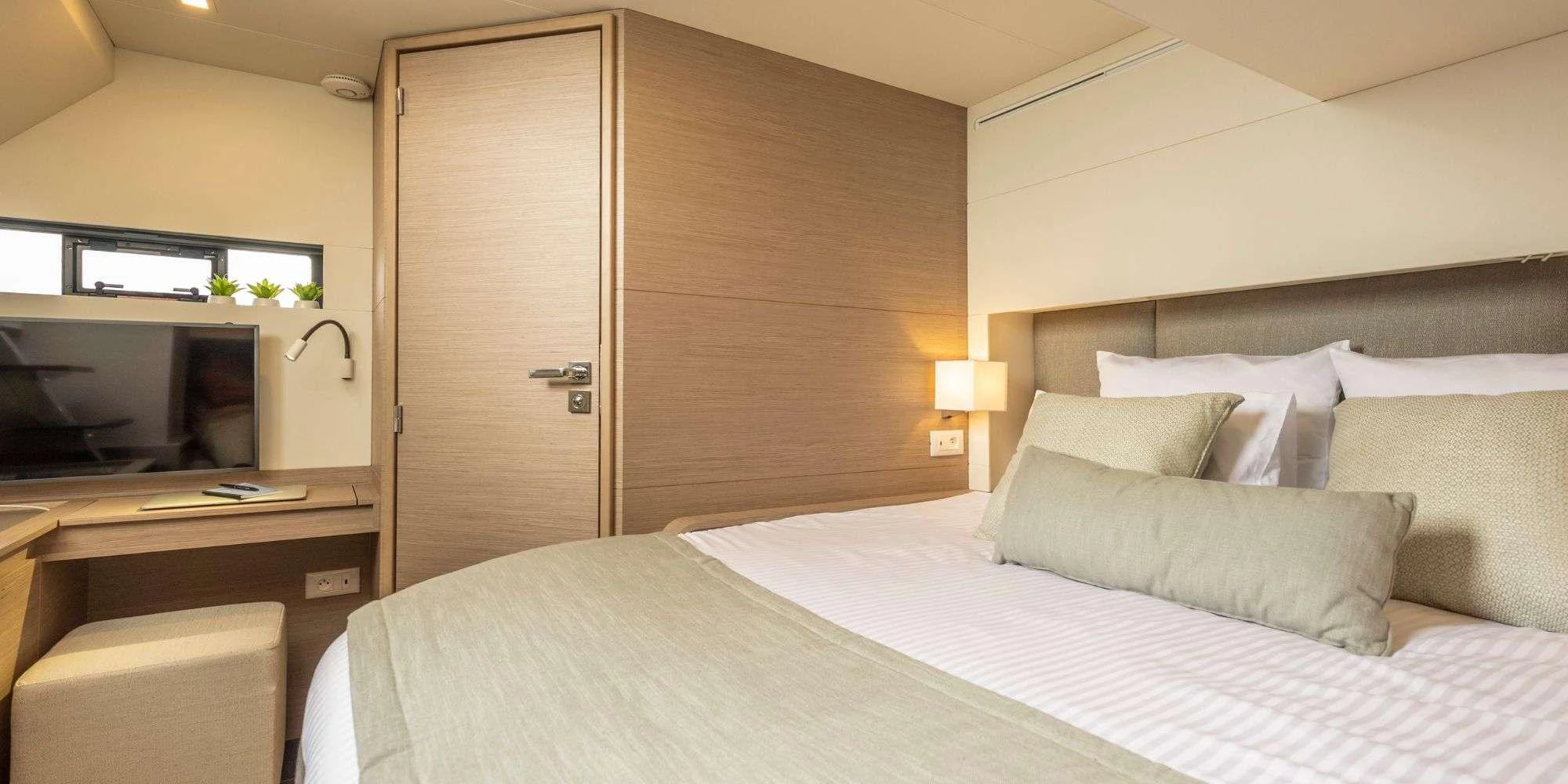 a bed with a white sheet and pillows aboard SEMPER FIDELIS Yacht for Charter