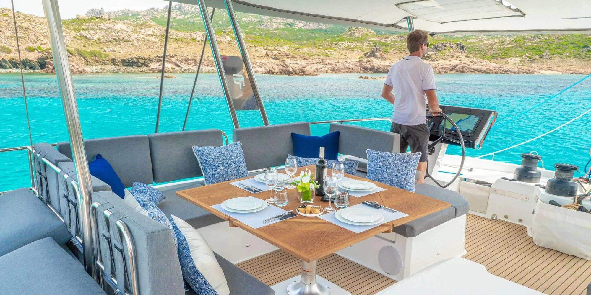 a person standing on a deck overlooking a body of water aboard SEMPER FIDELIS Yacht for Charter