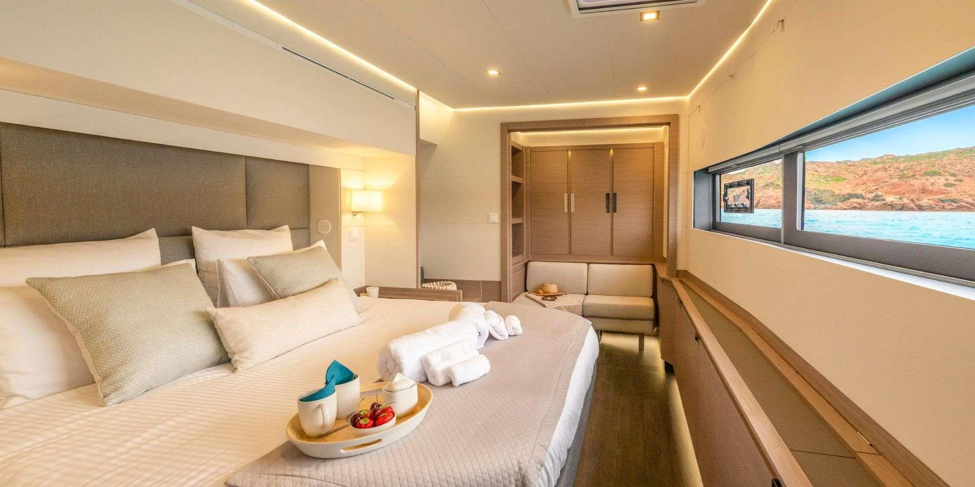 a bed and a couch in a room aboard SEMPER FIDELIS Yacht for Charter