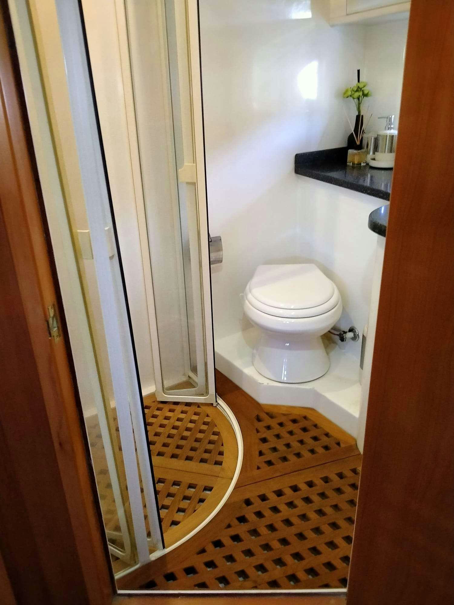 a bathroom with a glass door aboard SIROCCO Yacht for Charter