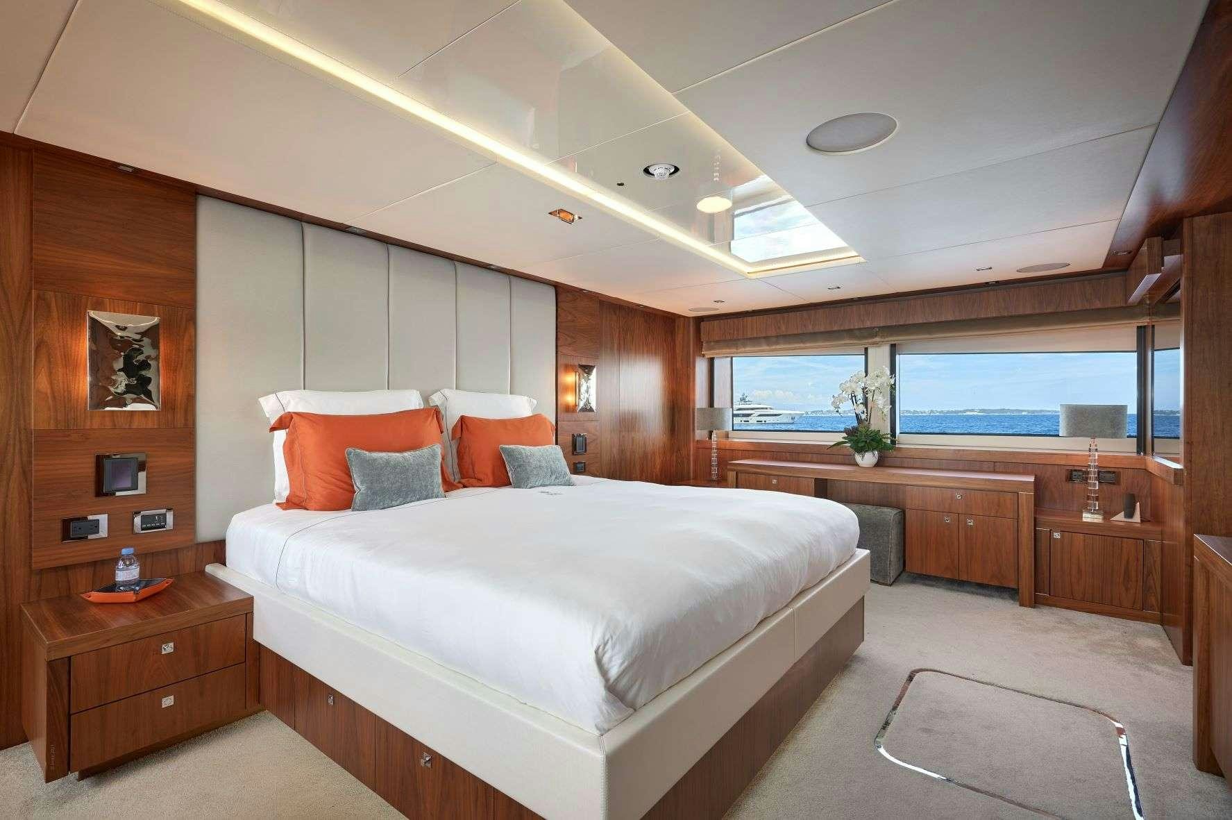 a bedroom with a large bed aboard EVEREAST Yacht for Charter