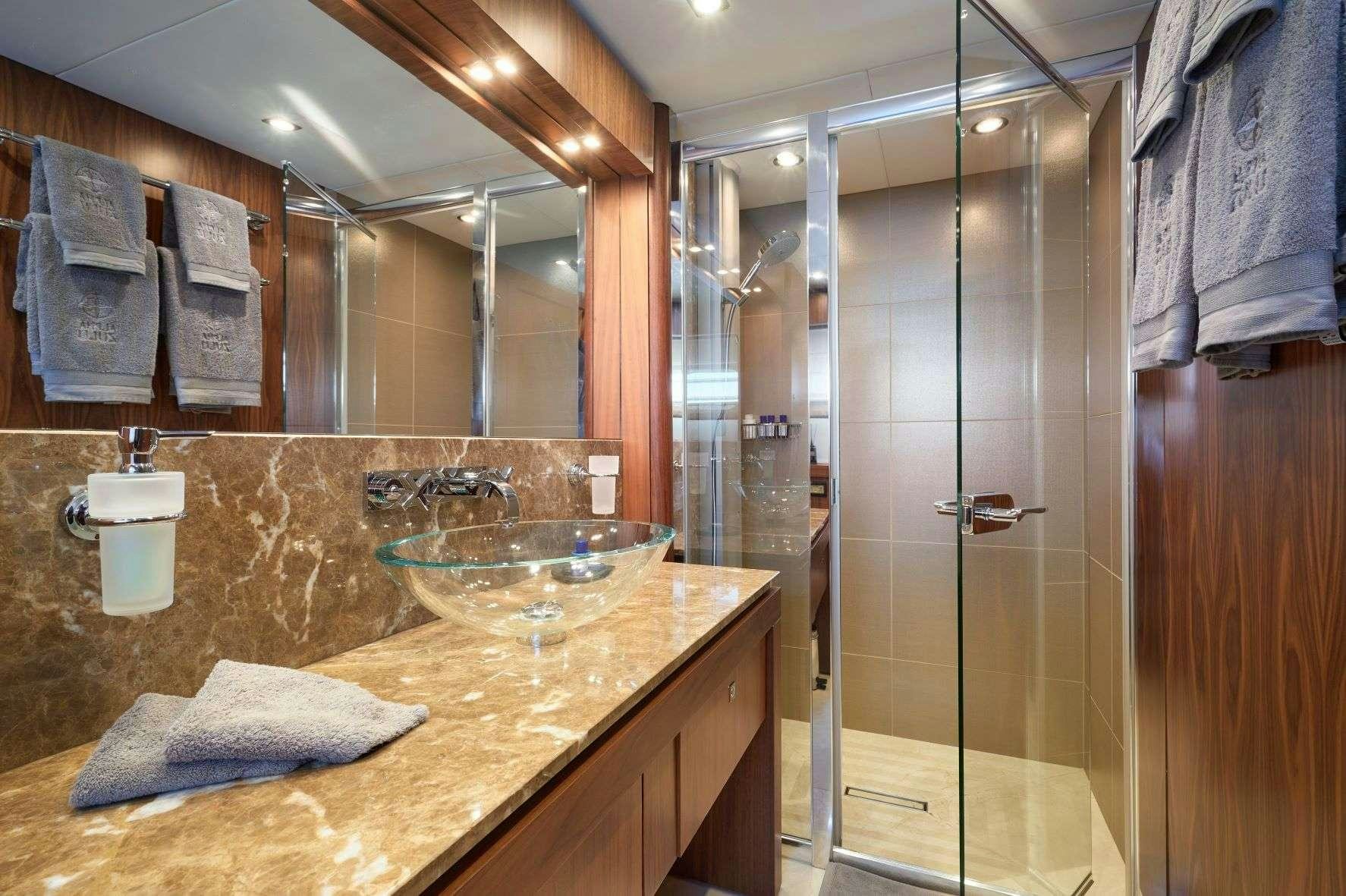 a bathroom with a glass shower aboard EVEREAST Yacht for Charter