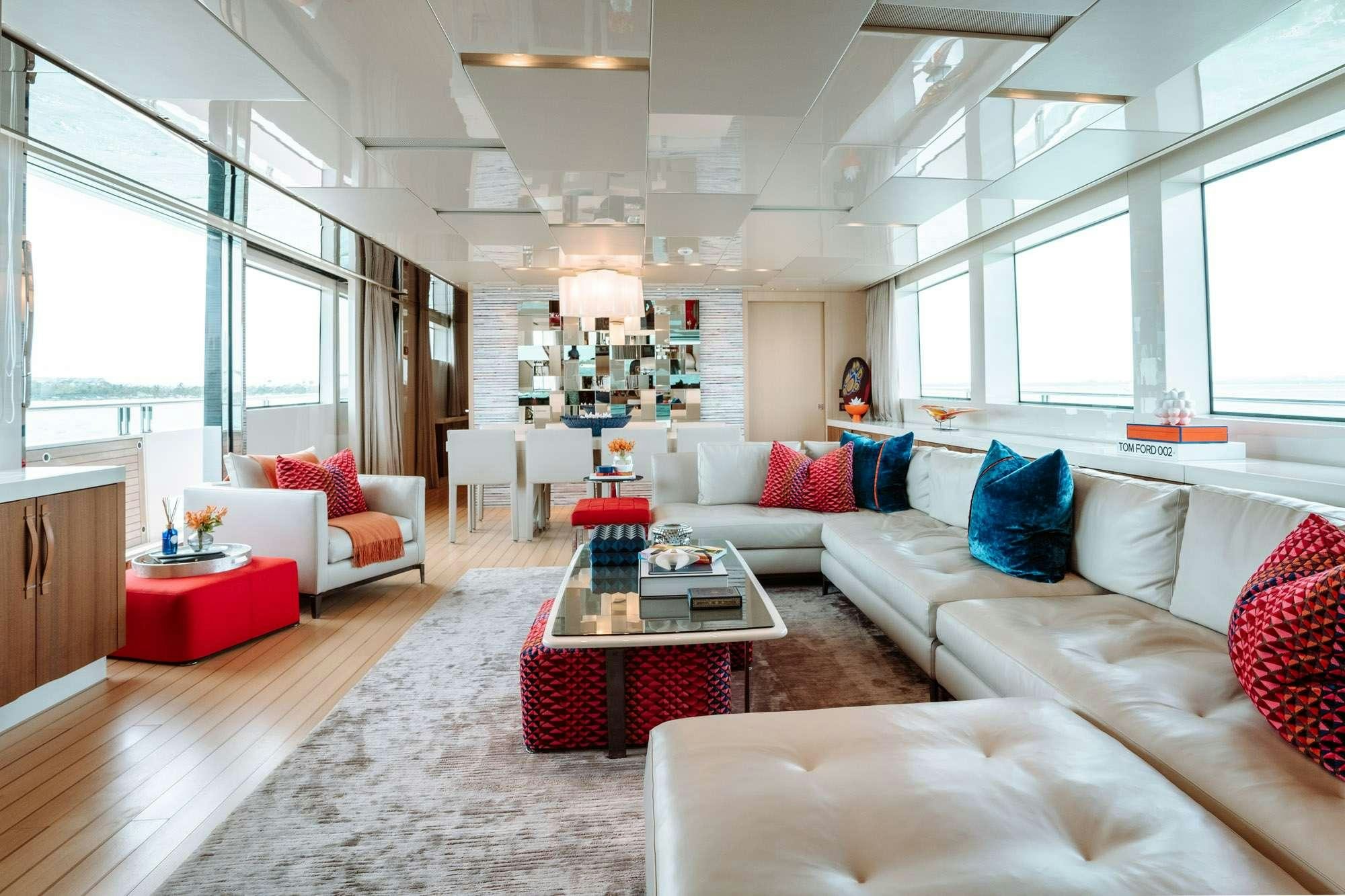 a living room with white couches and a table aboard FIFTY SHADES Yacht for Charter