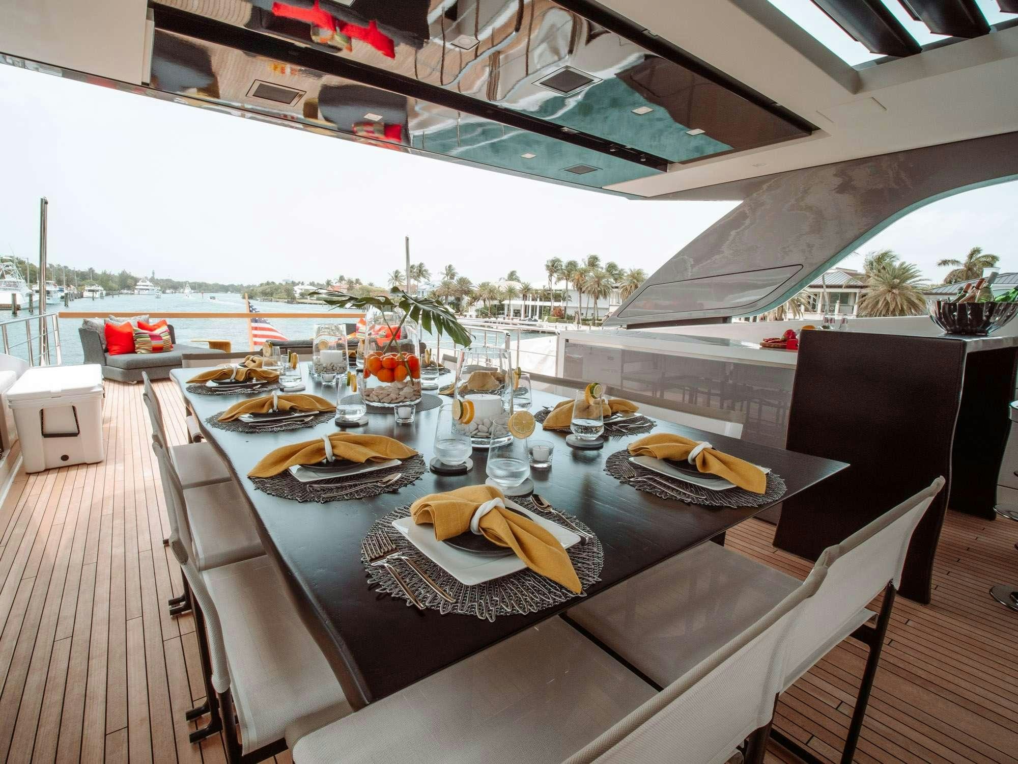 a table with plates and food on it aboard FIFTY SHADES Yacht for Charter