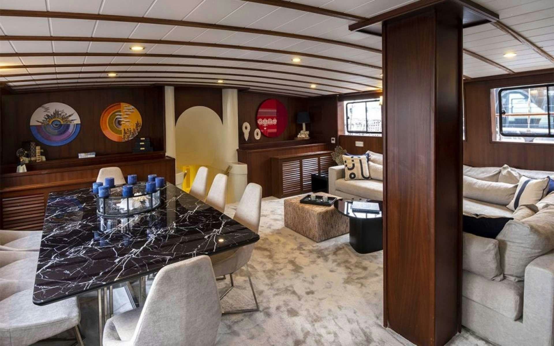 a room with a table and chairs aboard CAUSTIC Yacht for Charter