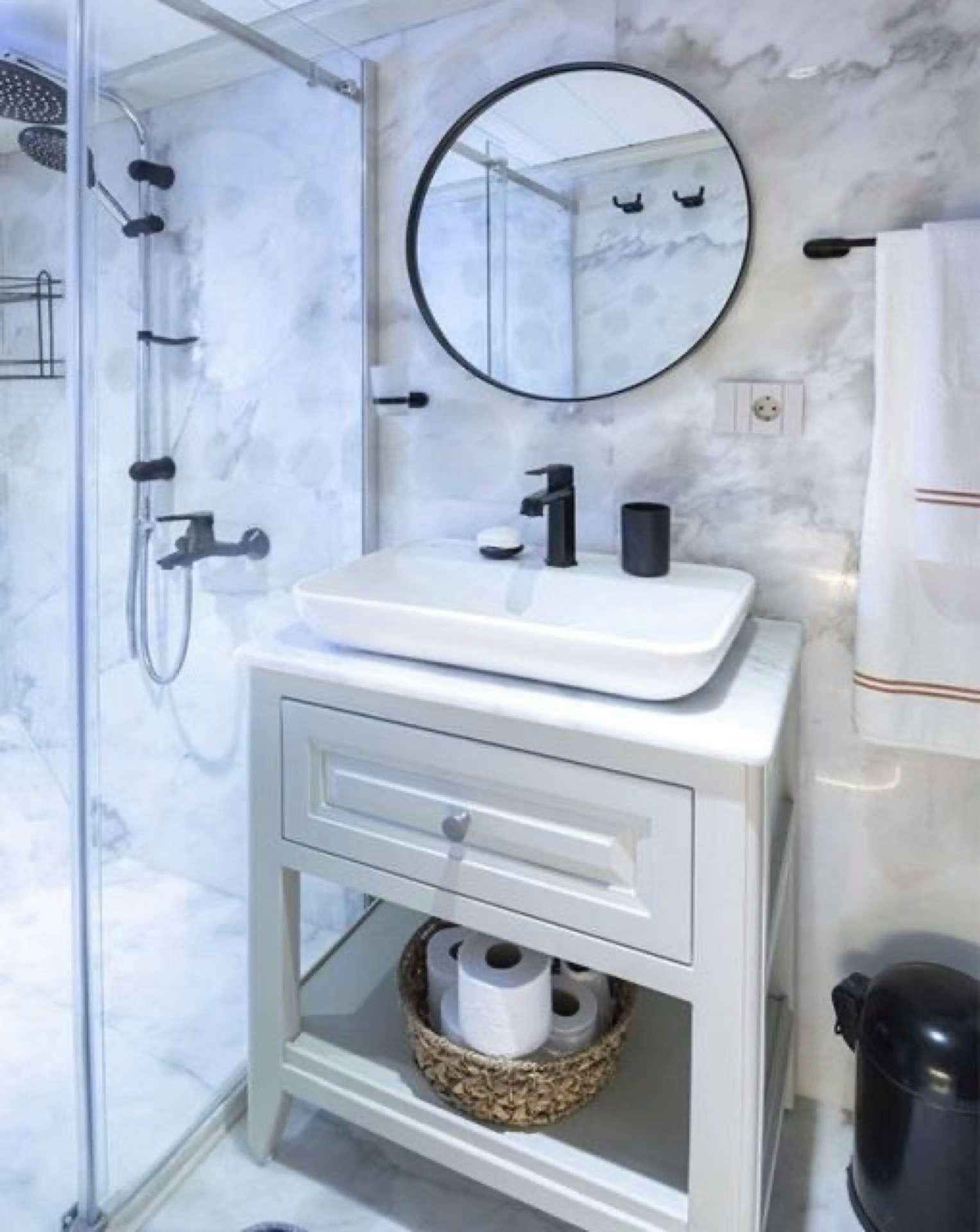 a bathroom with a sink and a mirror aboard CAUSTIC Yacht for Charter