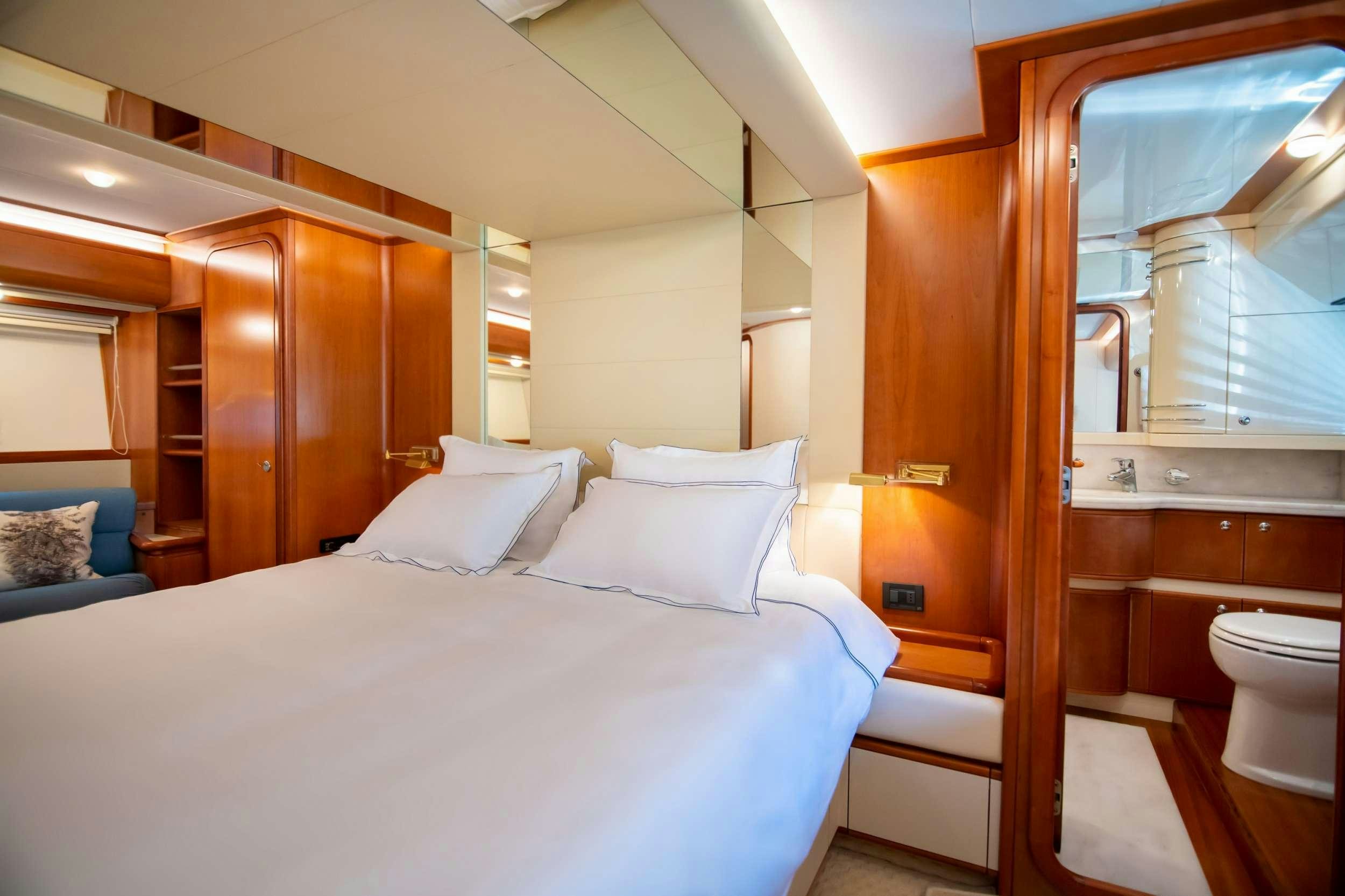 a room with a bed and a mirror aboard SOFIA D Yacht for Charter