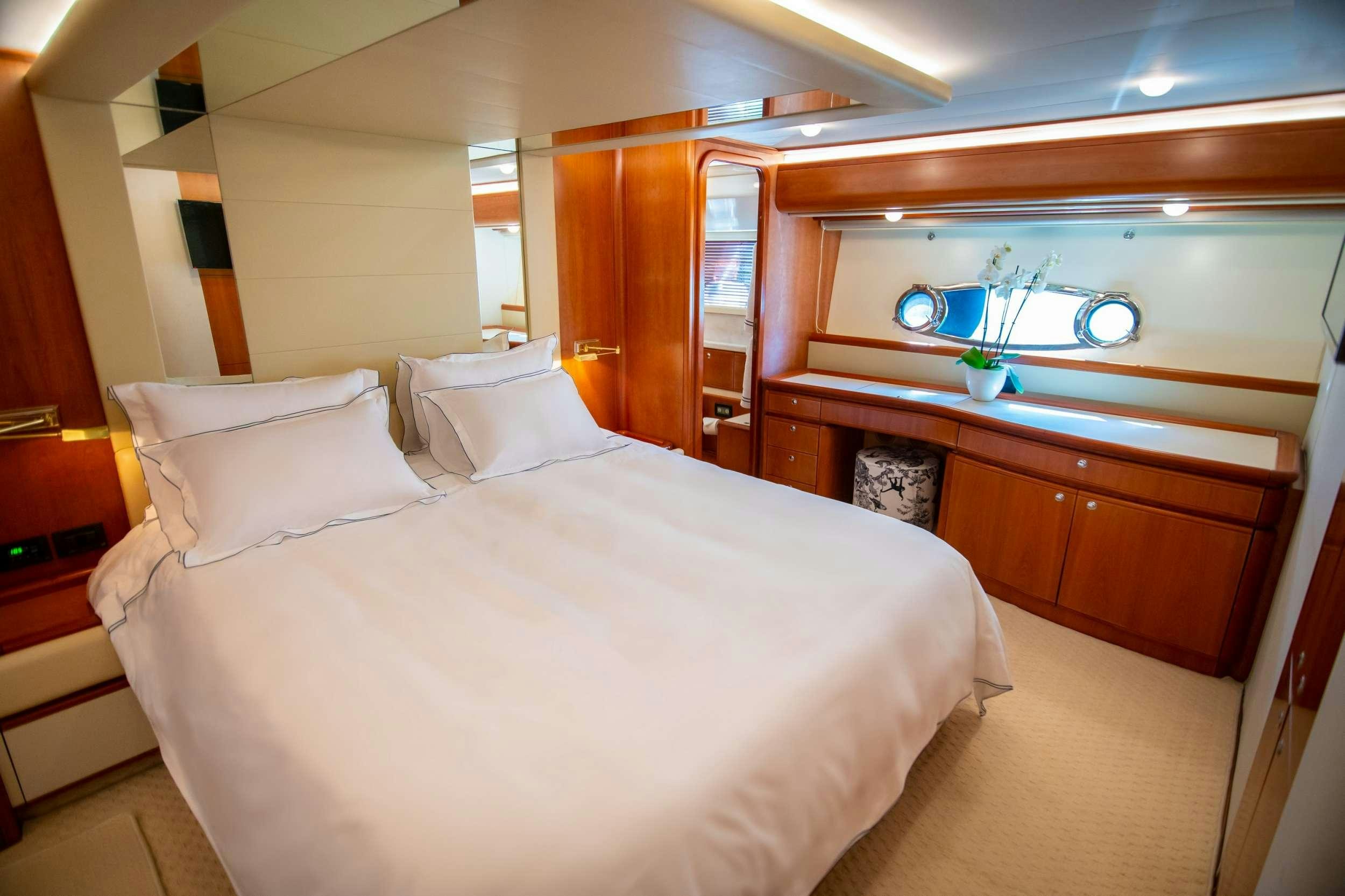 a bed with white sheets aboard SOFIA D Yacht for Charter