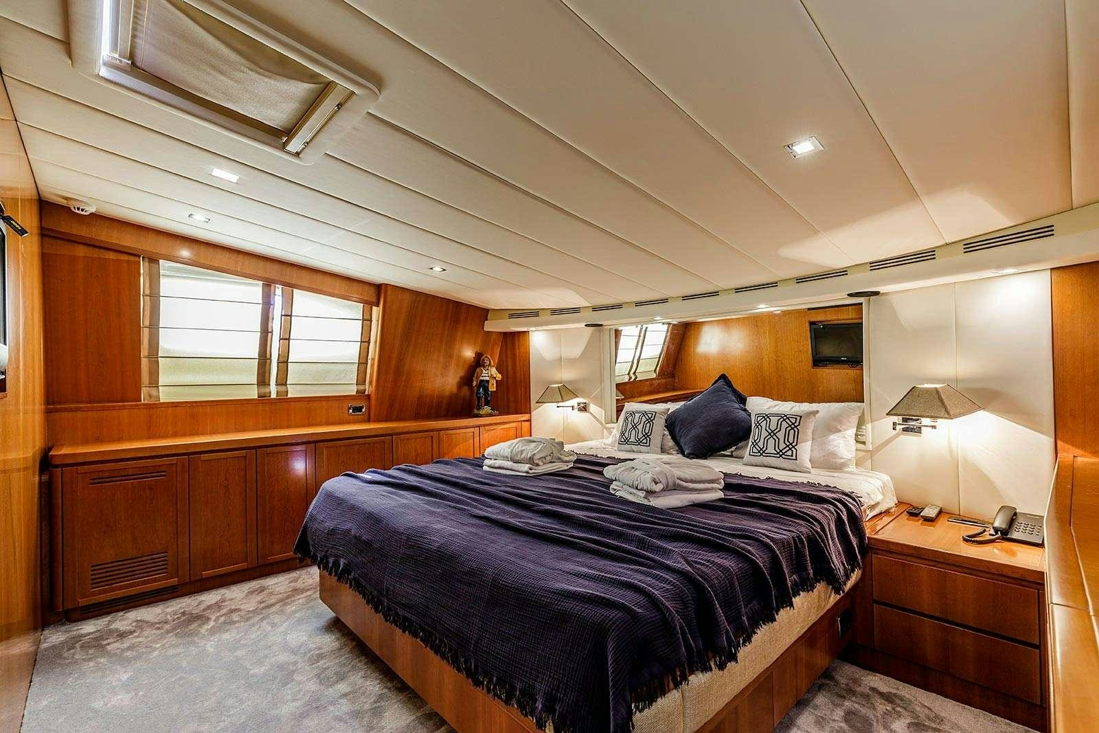 a bedroom with a bed and a desk aboard SANREF Yacht for Charter