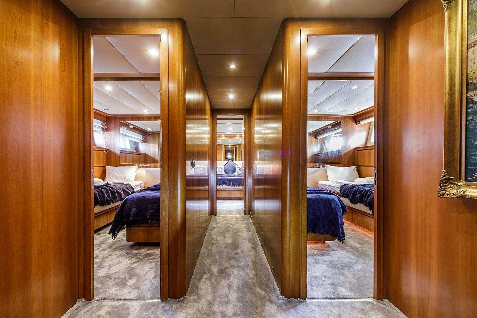 a room with wood walls and a bed aboard SANREF Yacht for Charter