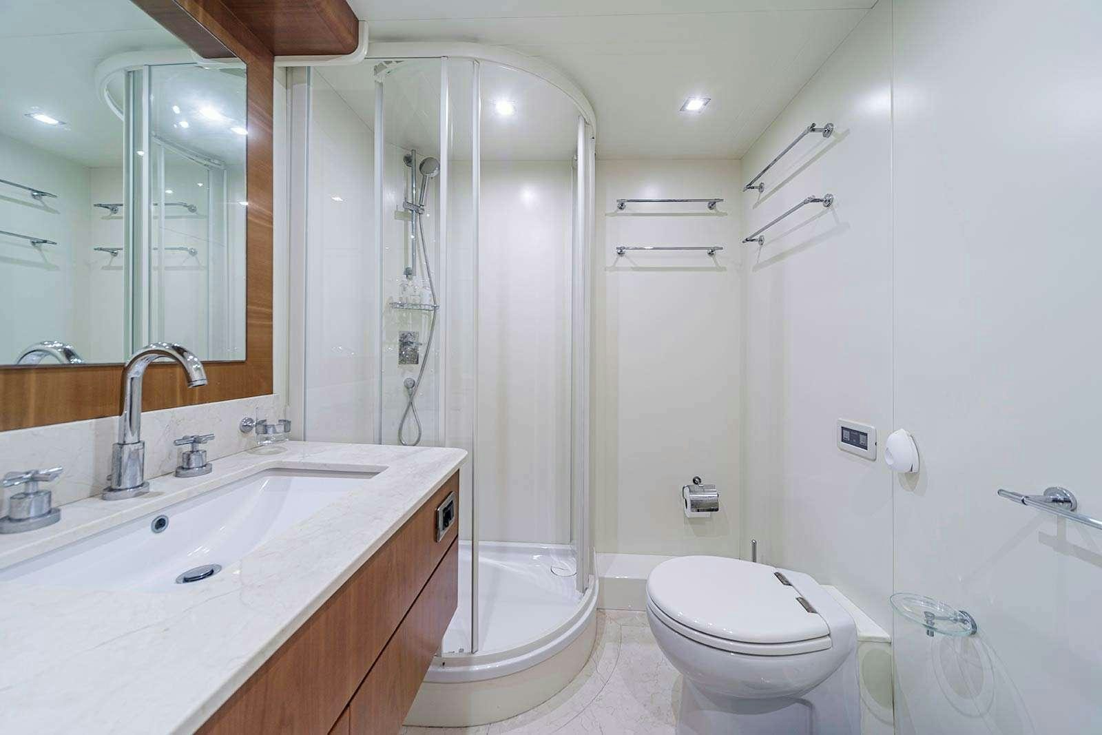 a bathroom with a shower sink and toilet aboard SANREF Yacht for Charter