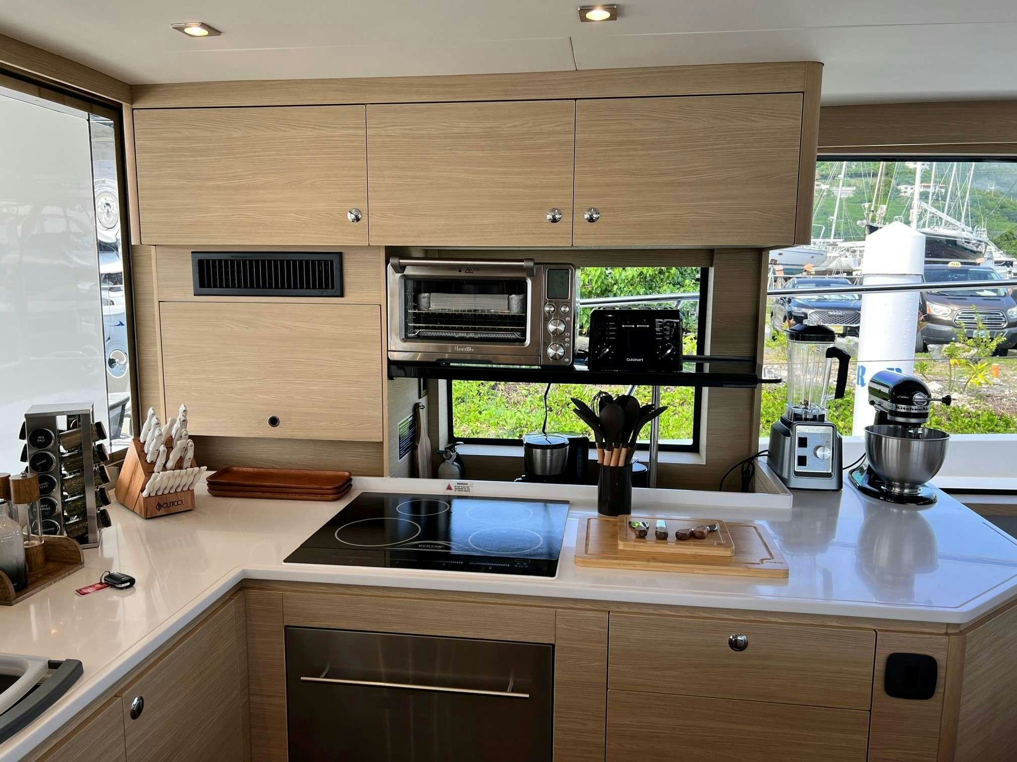 a kitchen with a stove and a microwave oven aboard GO TEAM Yacht for Charter