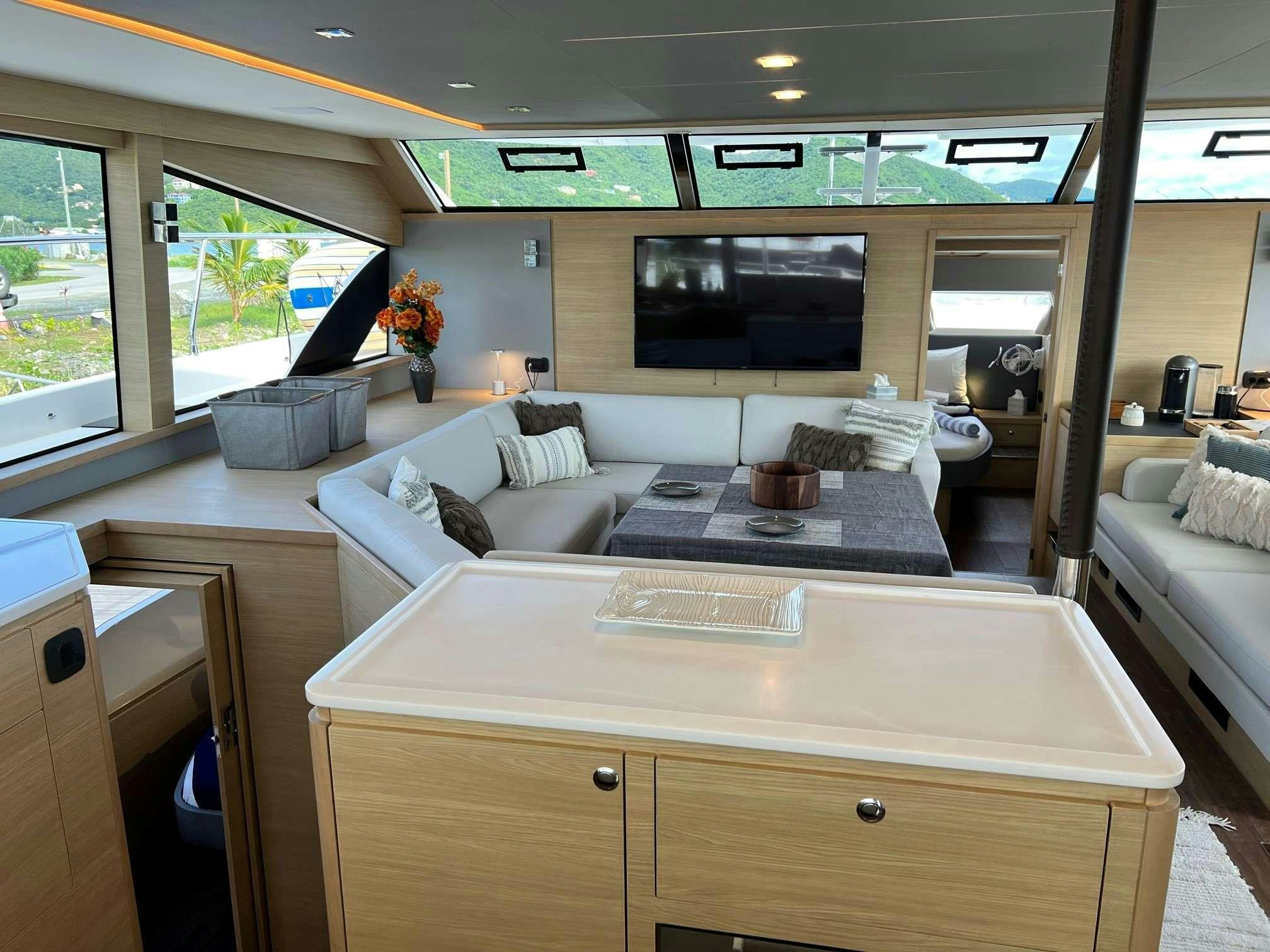 a room with a couch and a table aboard GO TEAM Yacht for Charter