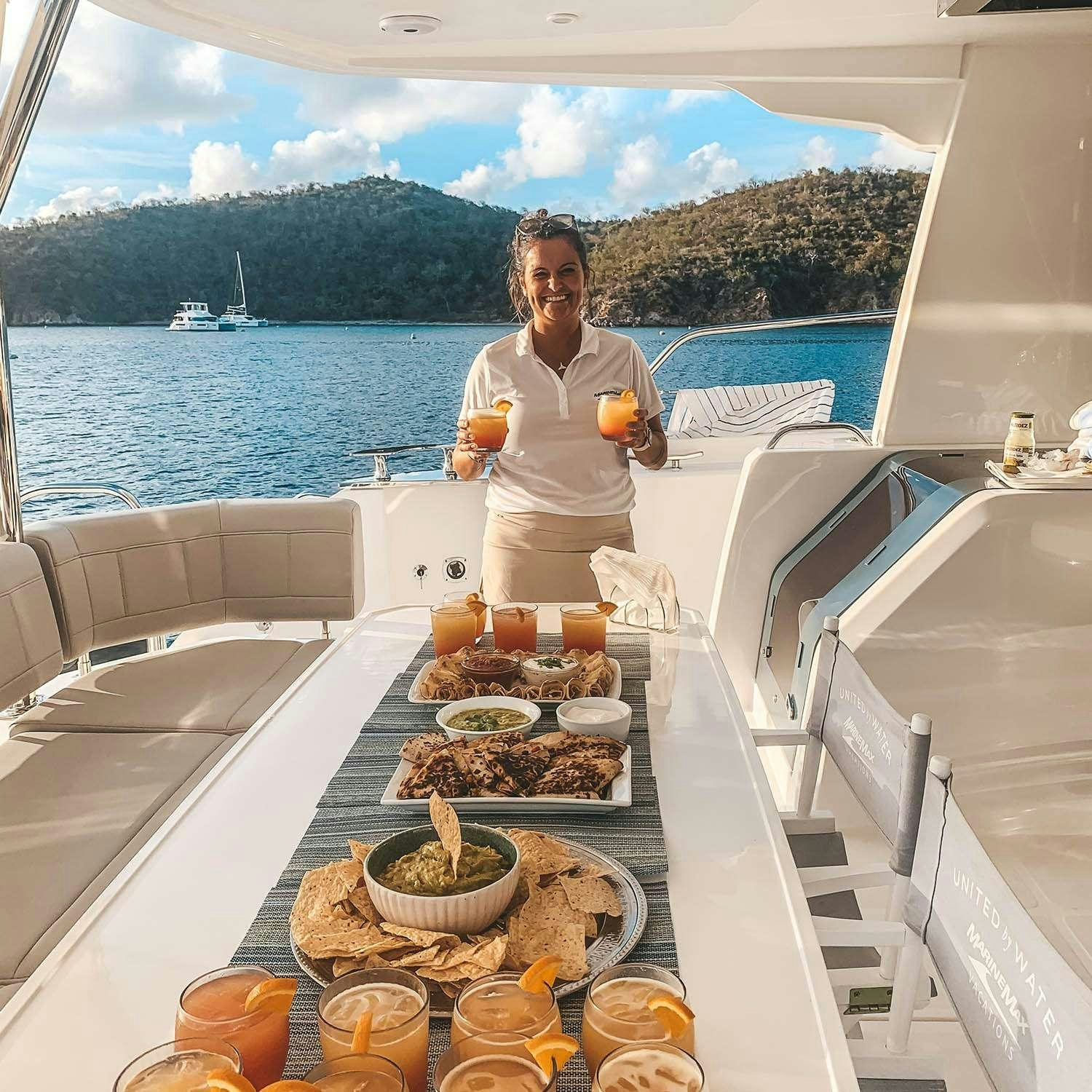 a person standing in a kitchen aboard GO TEAM Yacht for Charter