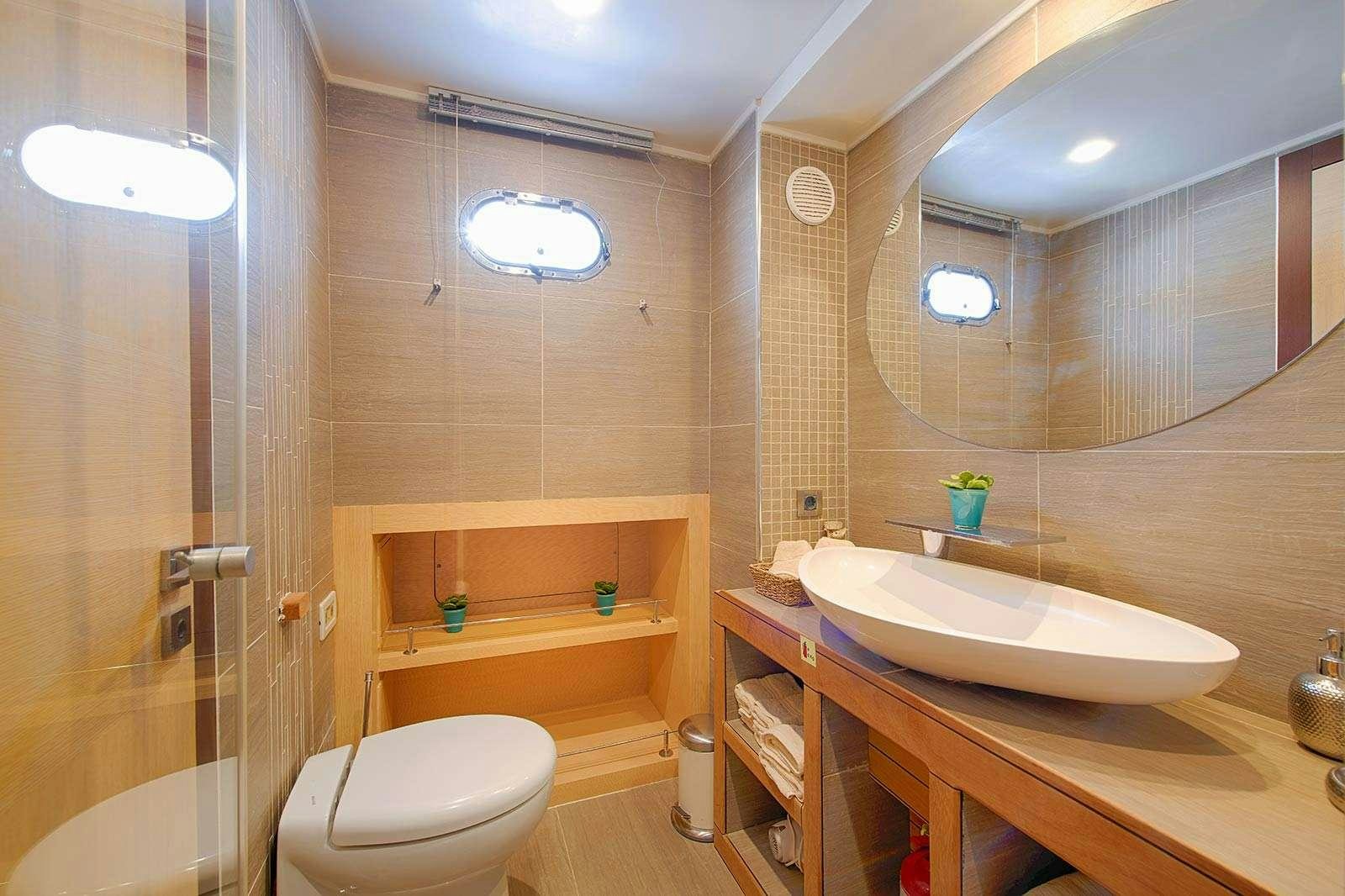 a bathroom with a sink toilet and bathtub aboard THE WALL Yacht for Charter