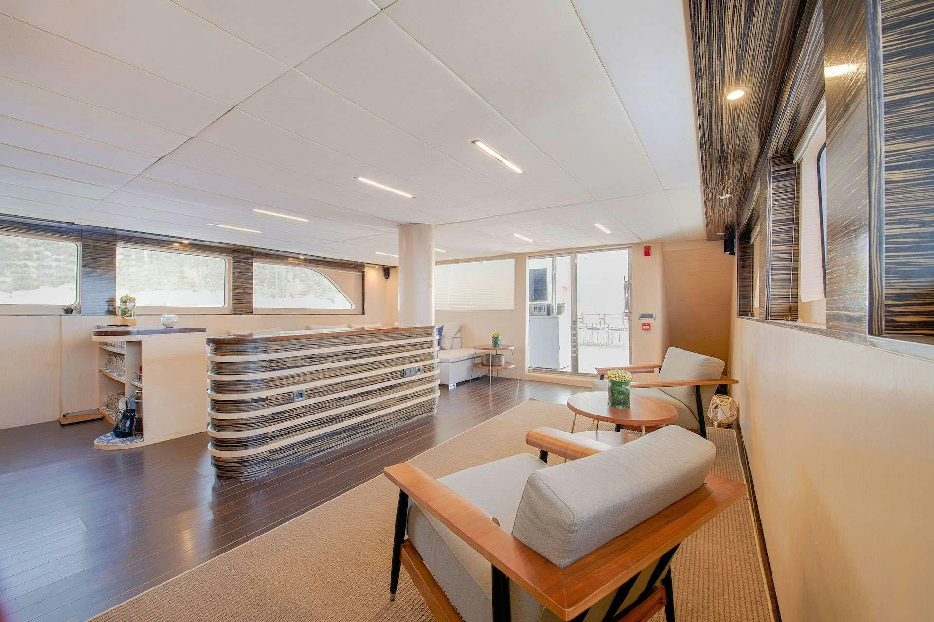 a room with a table and chairs aboard THE WALL Yacht for Charter